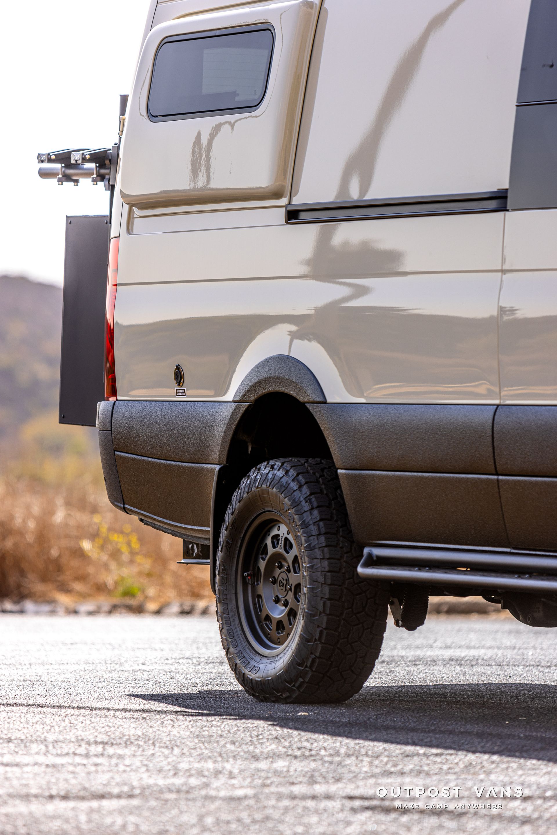 A white van is parked on the side of the road.