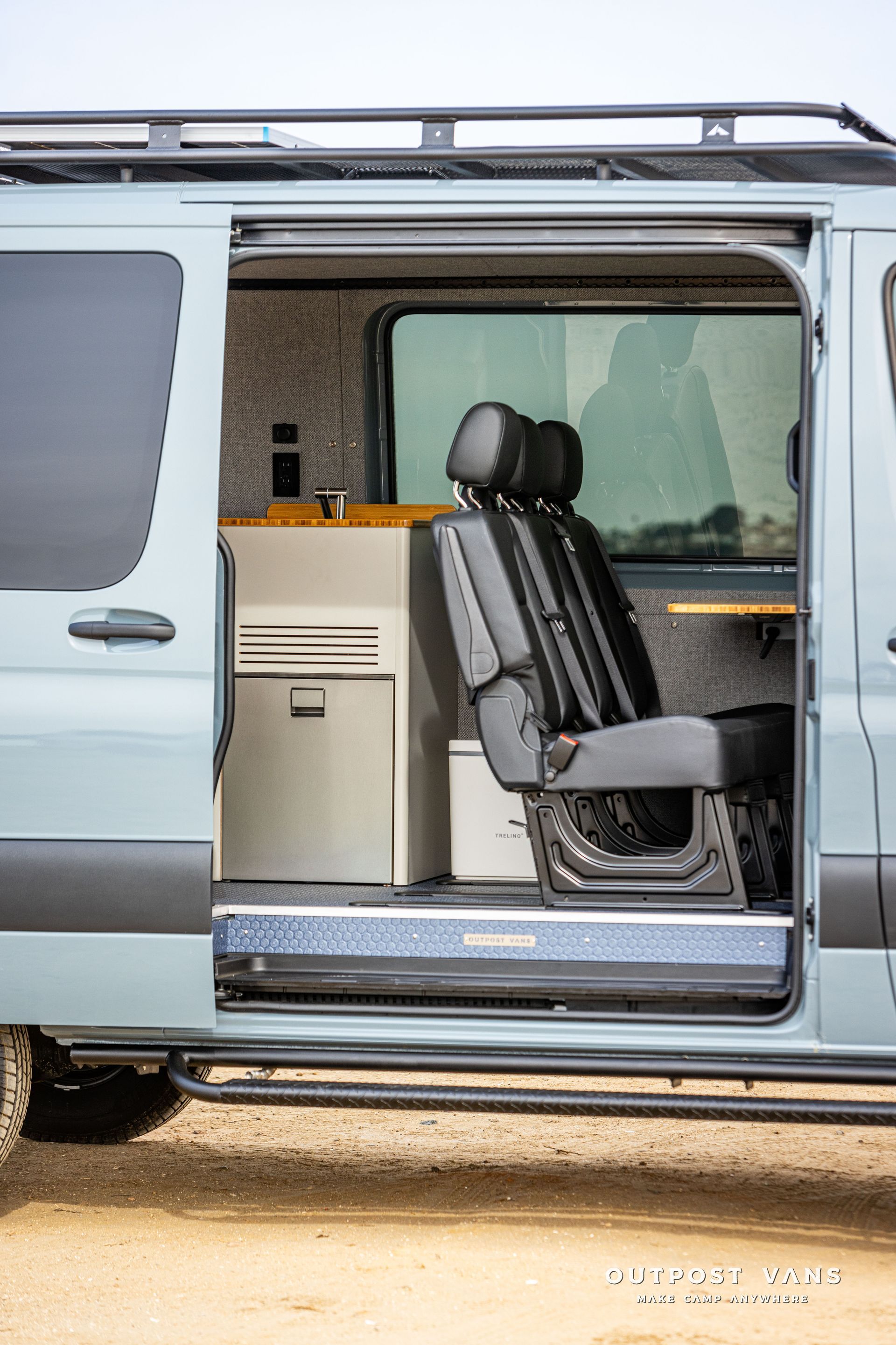 A van with the door open and the seats folded down.