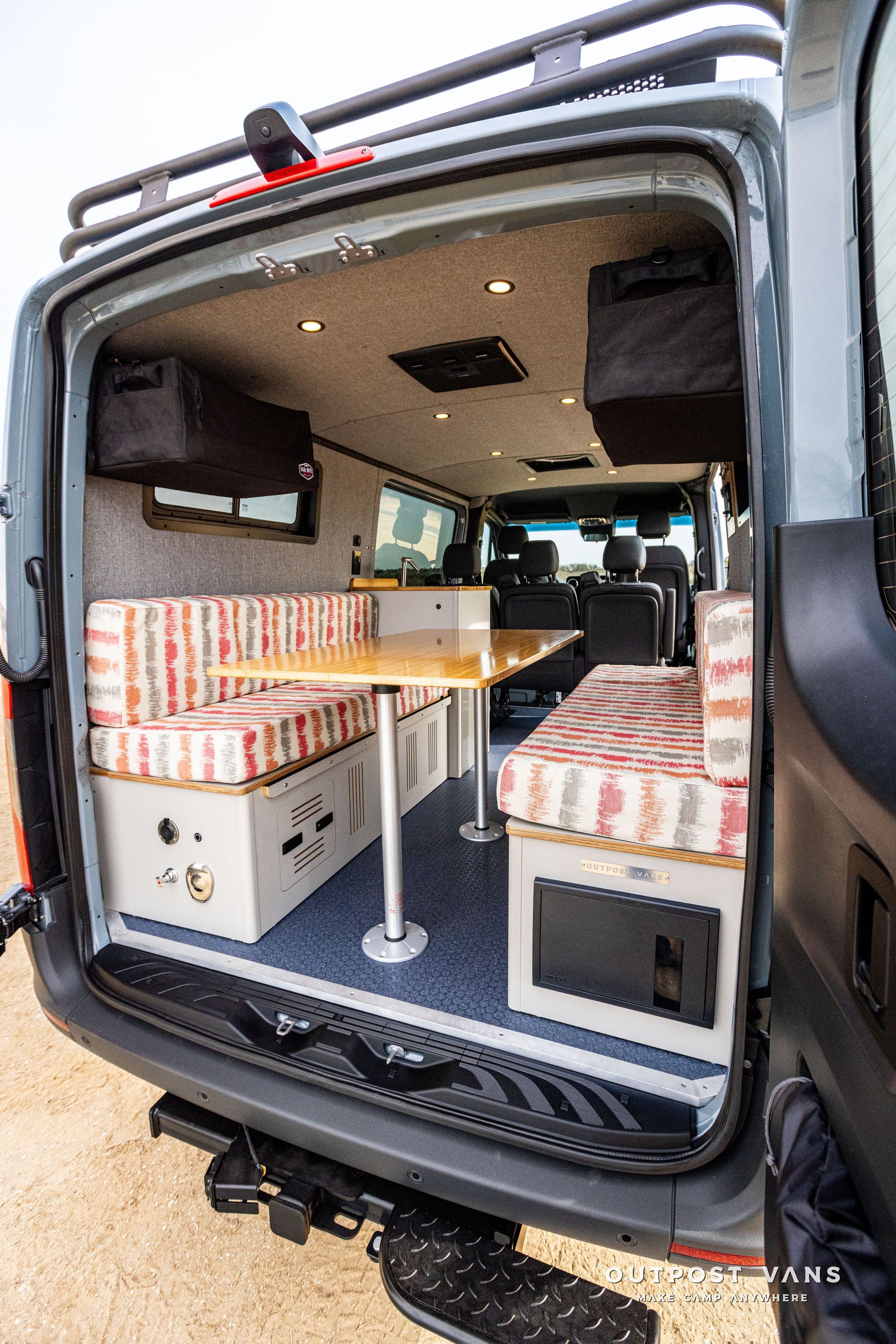 The back of a camper van with the door open.