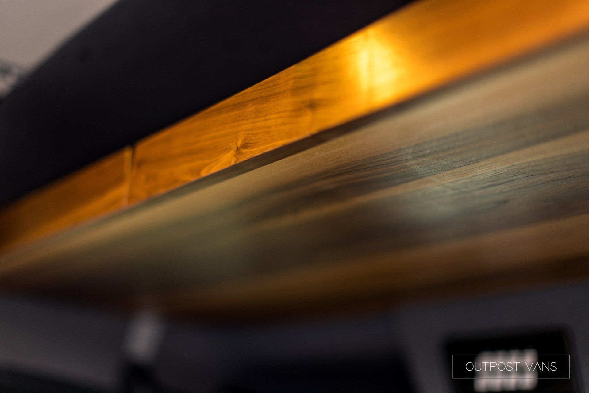 A close up of a wooden table with a light on it.