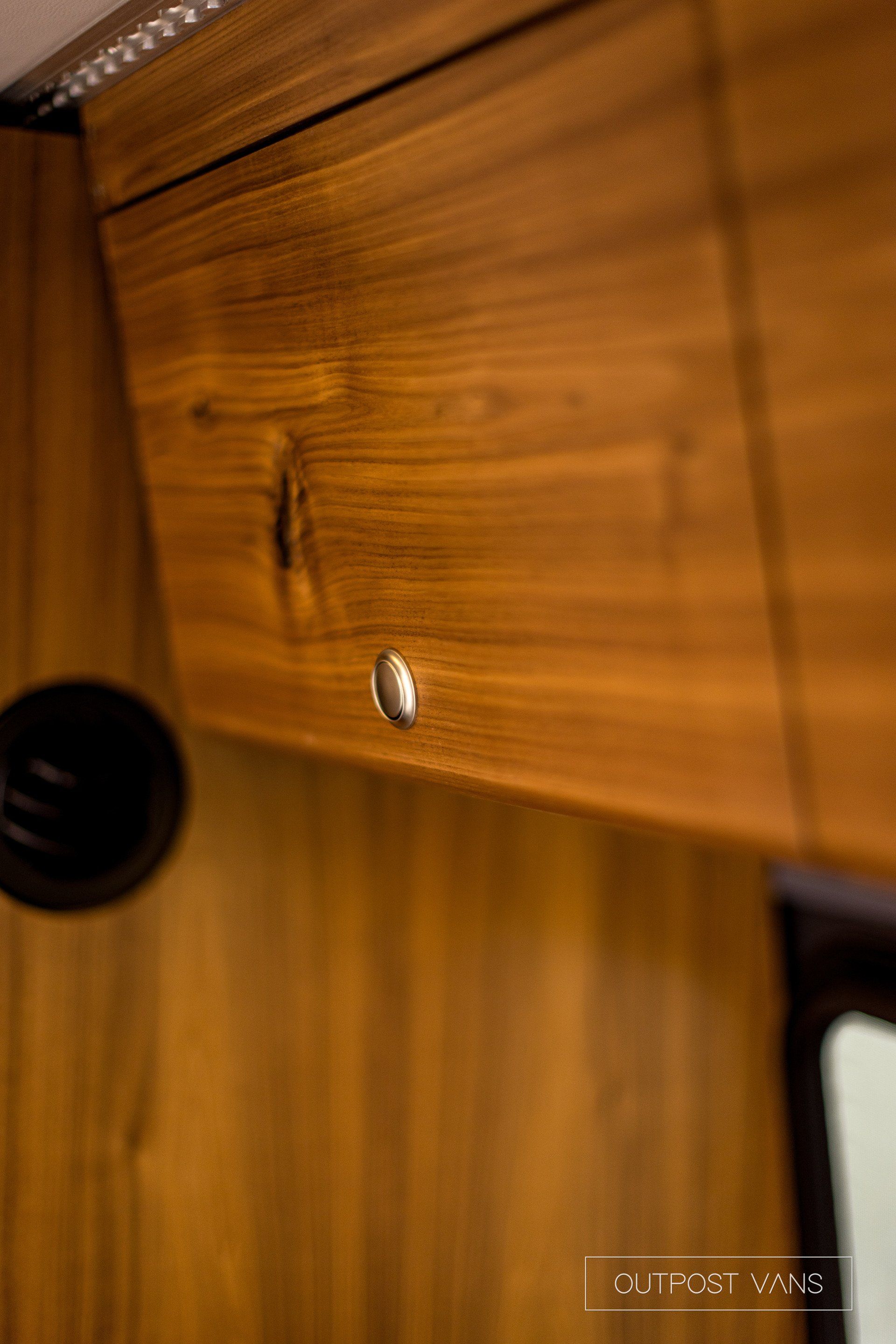 A close up of a wooden cabinet in a room.