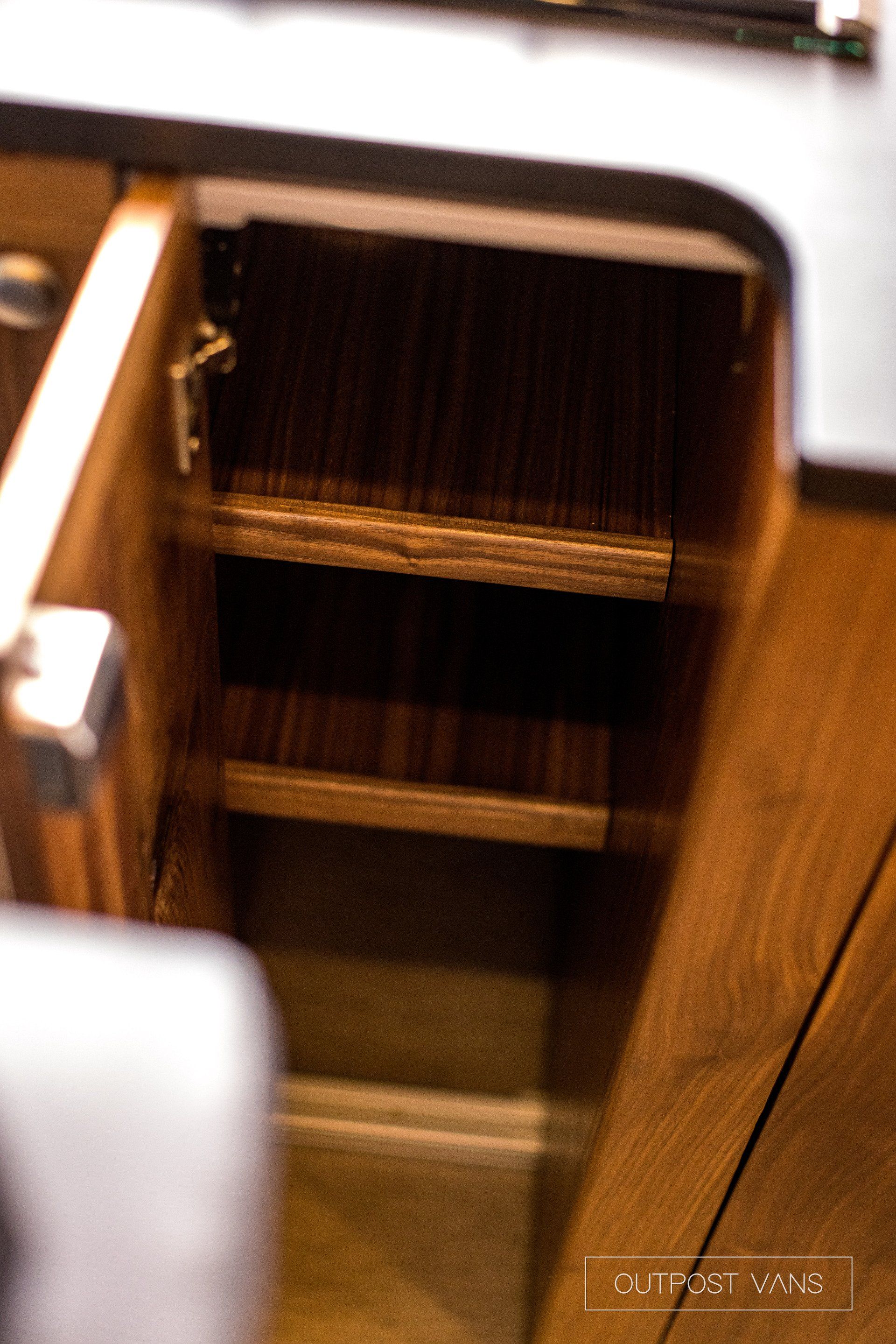 A close up of a wooden shelf in a kitchen