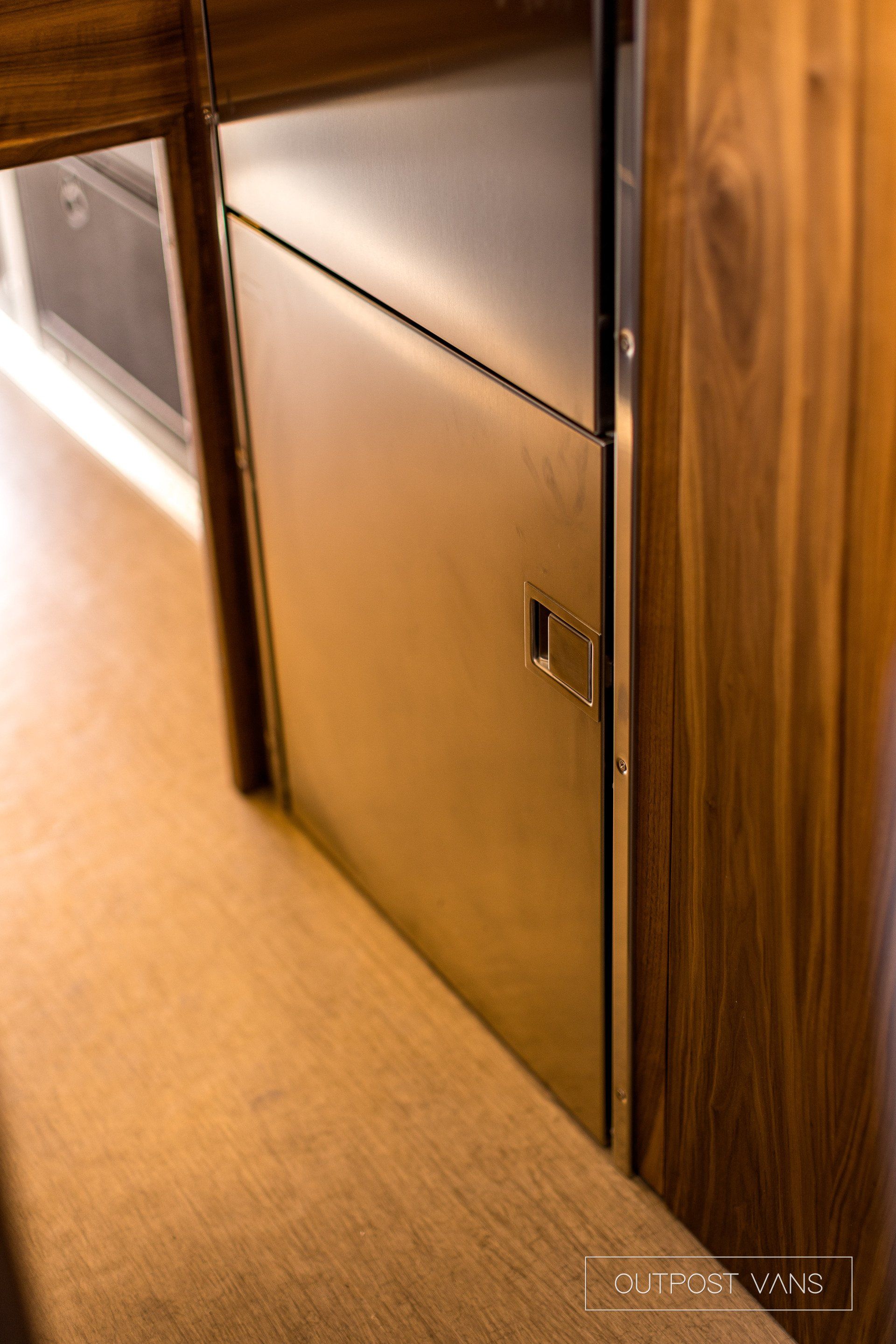 A close up of a stainless steel door in a kitchen