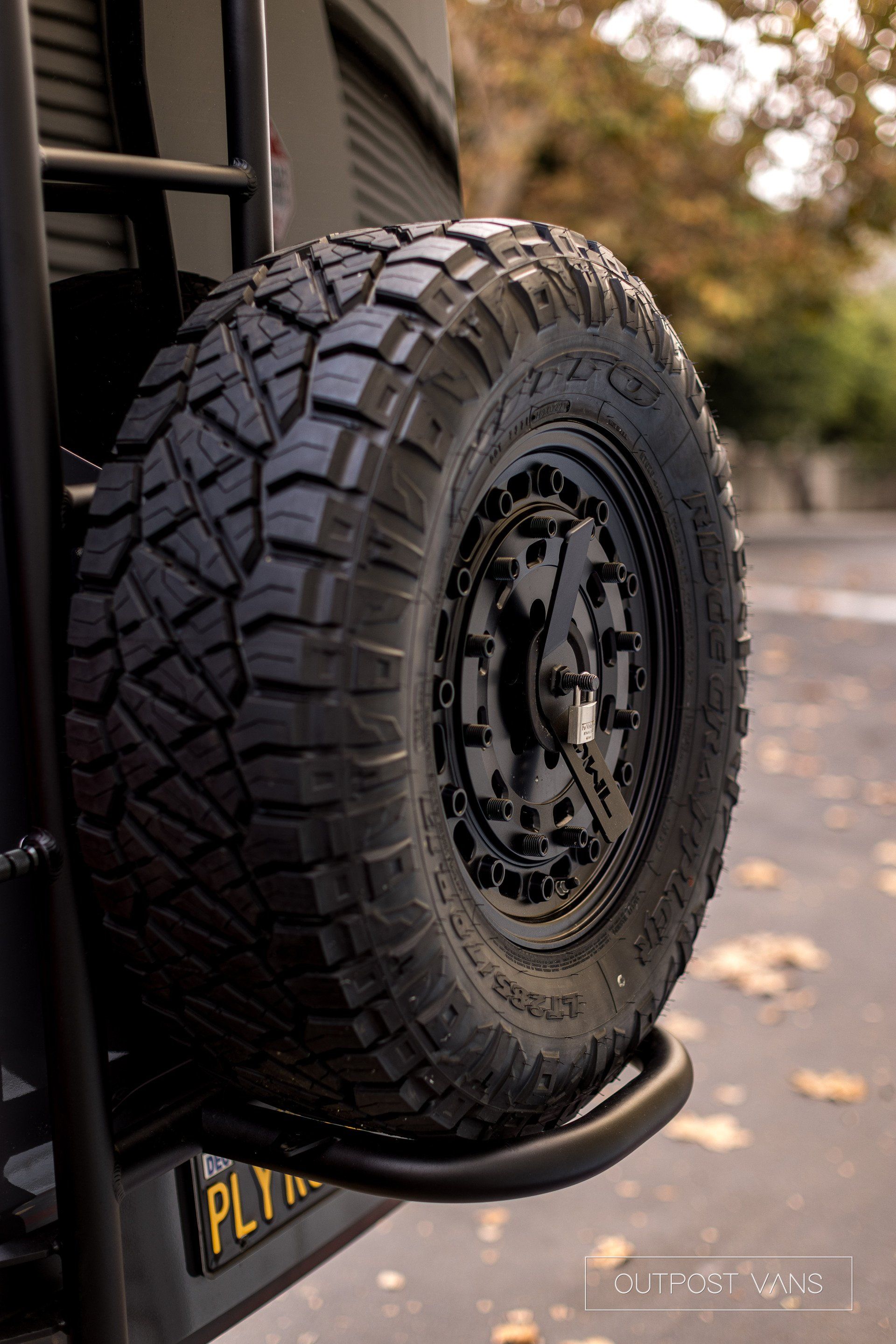 a close up of a tire on the back of a vehicle .
