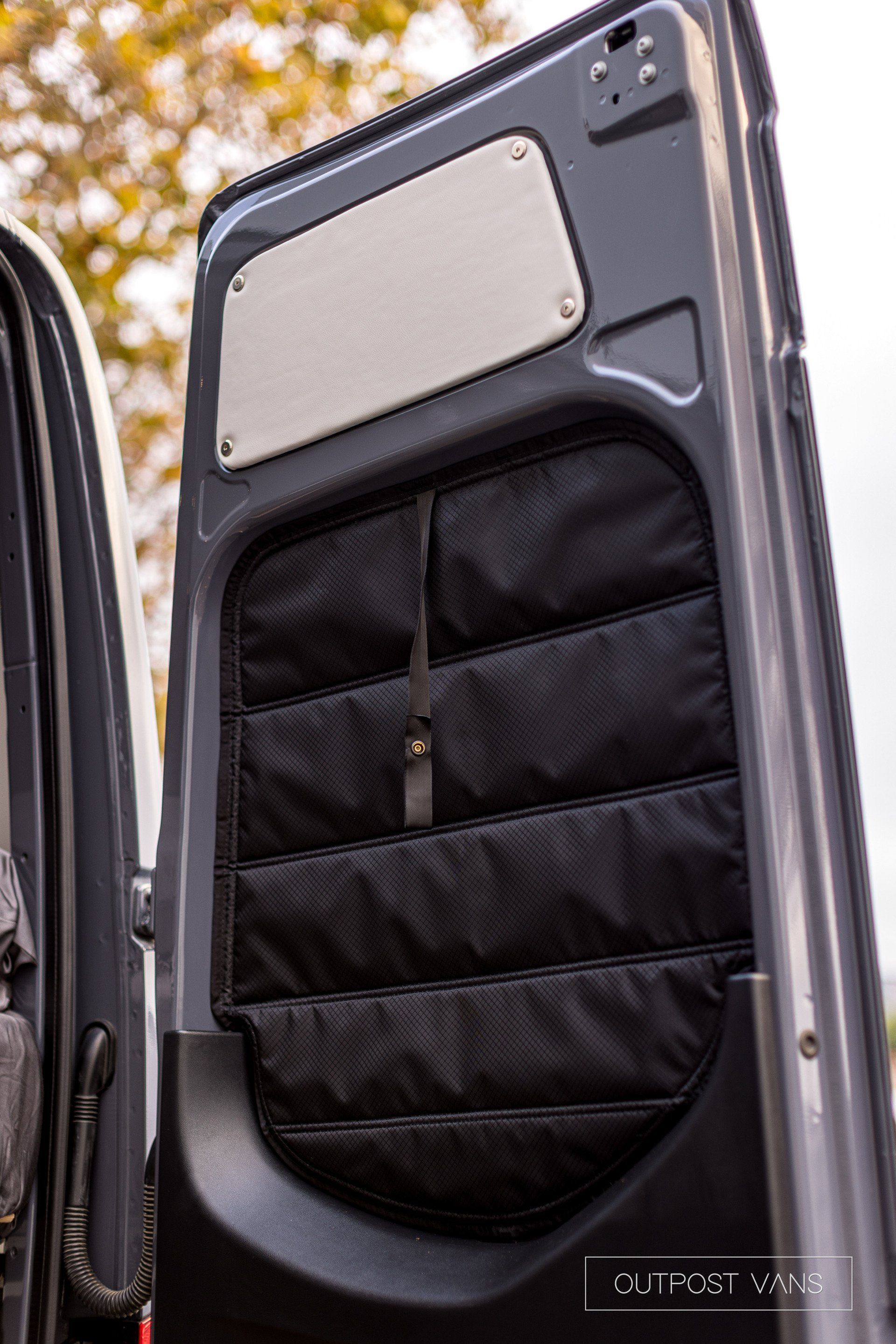 A close up of the back door of a van with the door open.