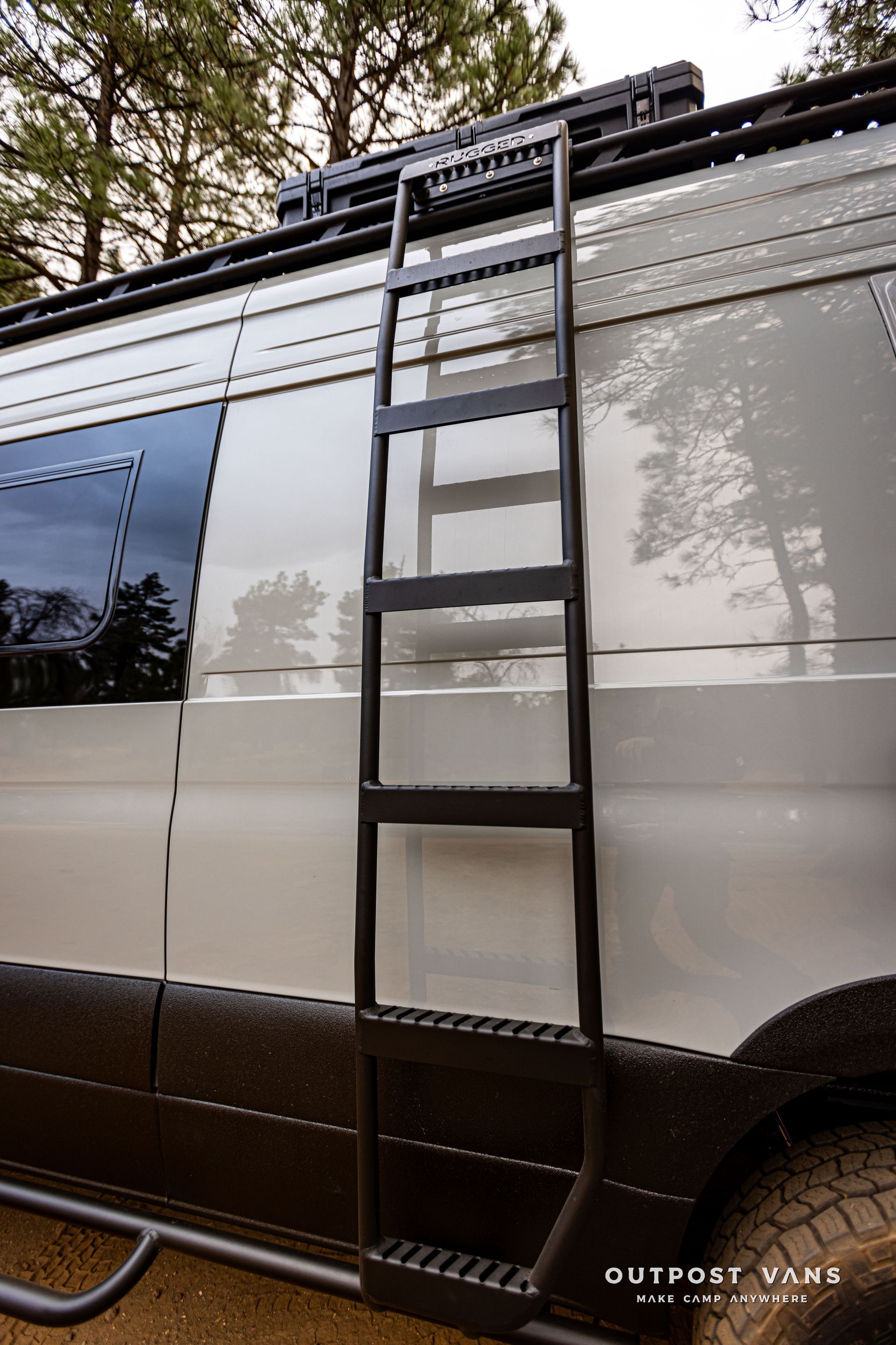 A van with a ladder attached to the side of it.