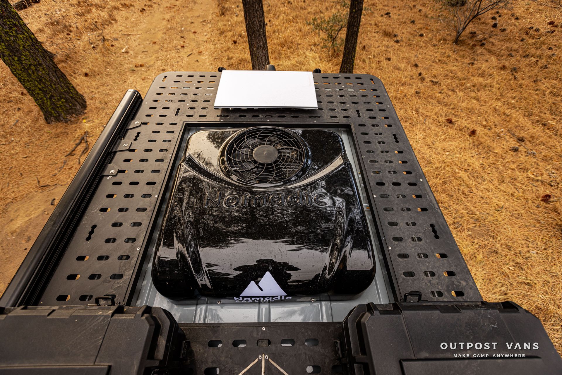 A black tank with a fan on top of it.