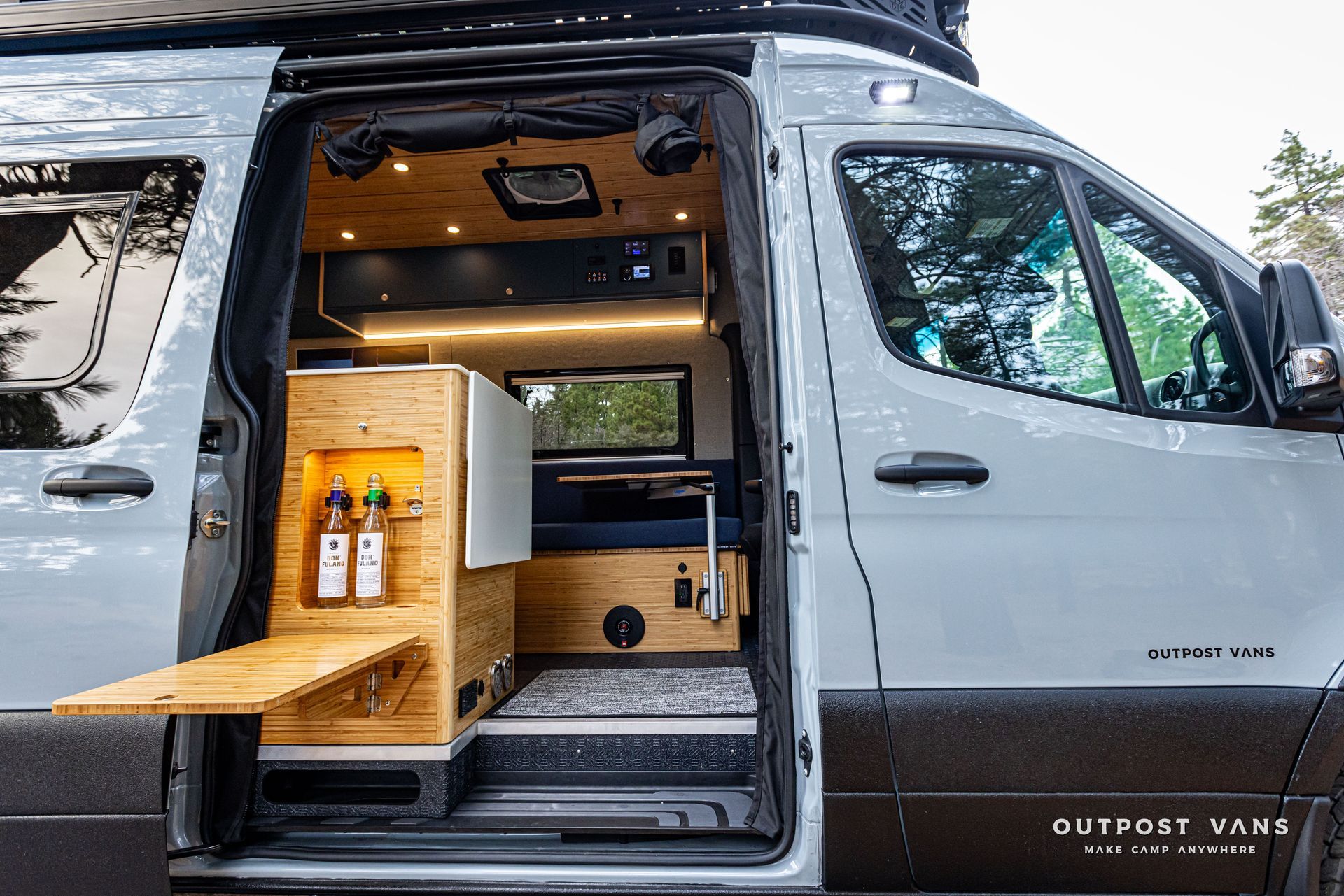 The inside of a van with the door open and A FLIP DOWN TABLE