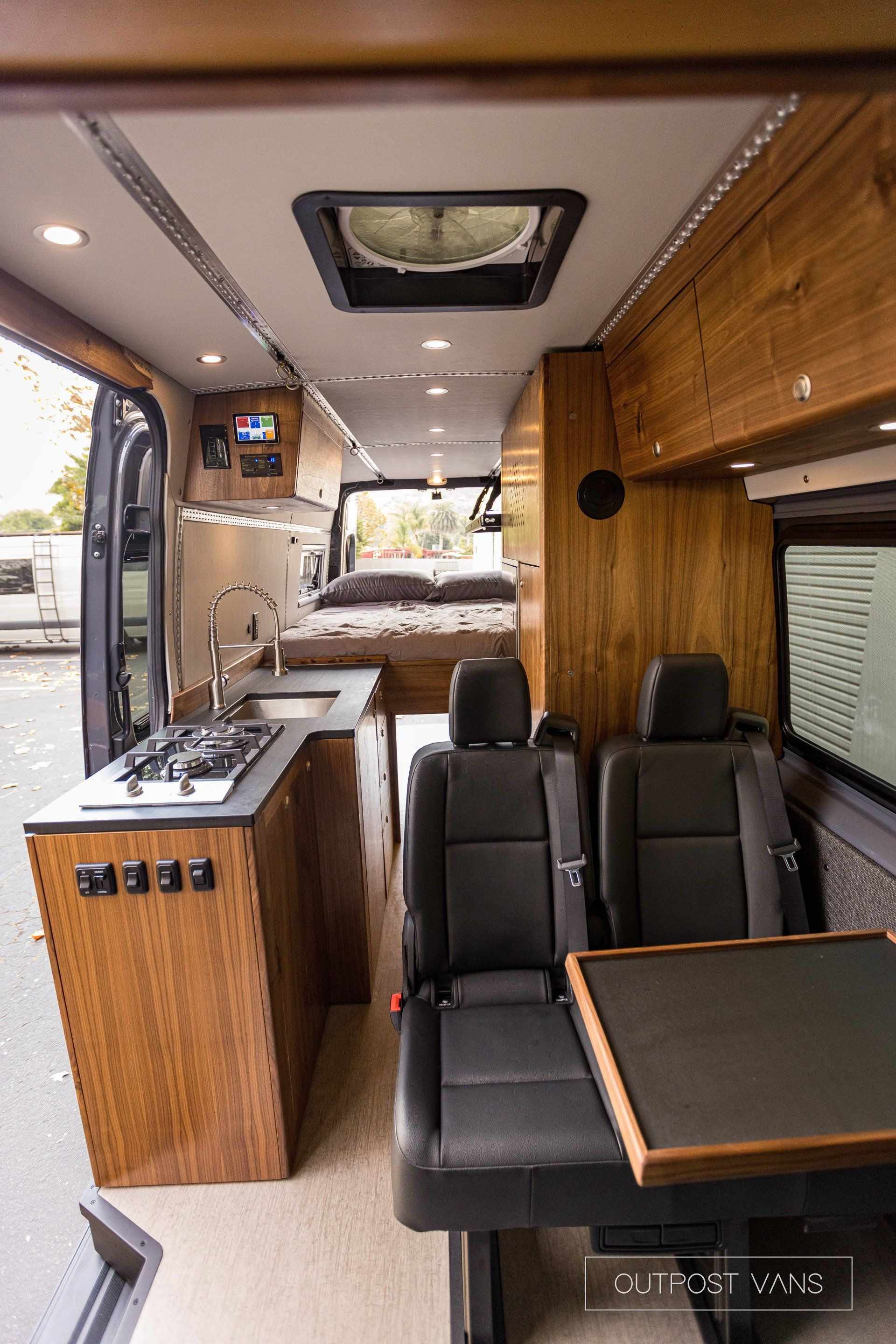 The inside of a van with a table and chairs.