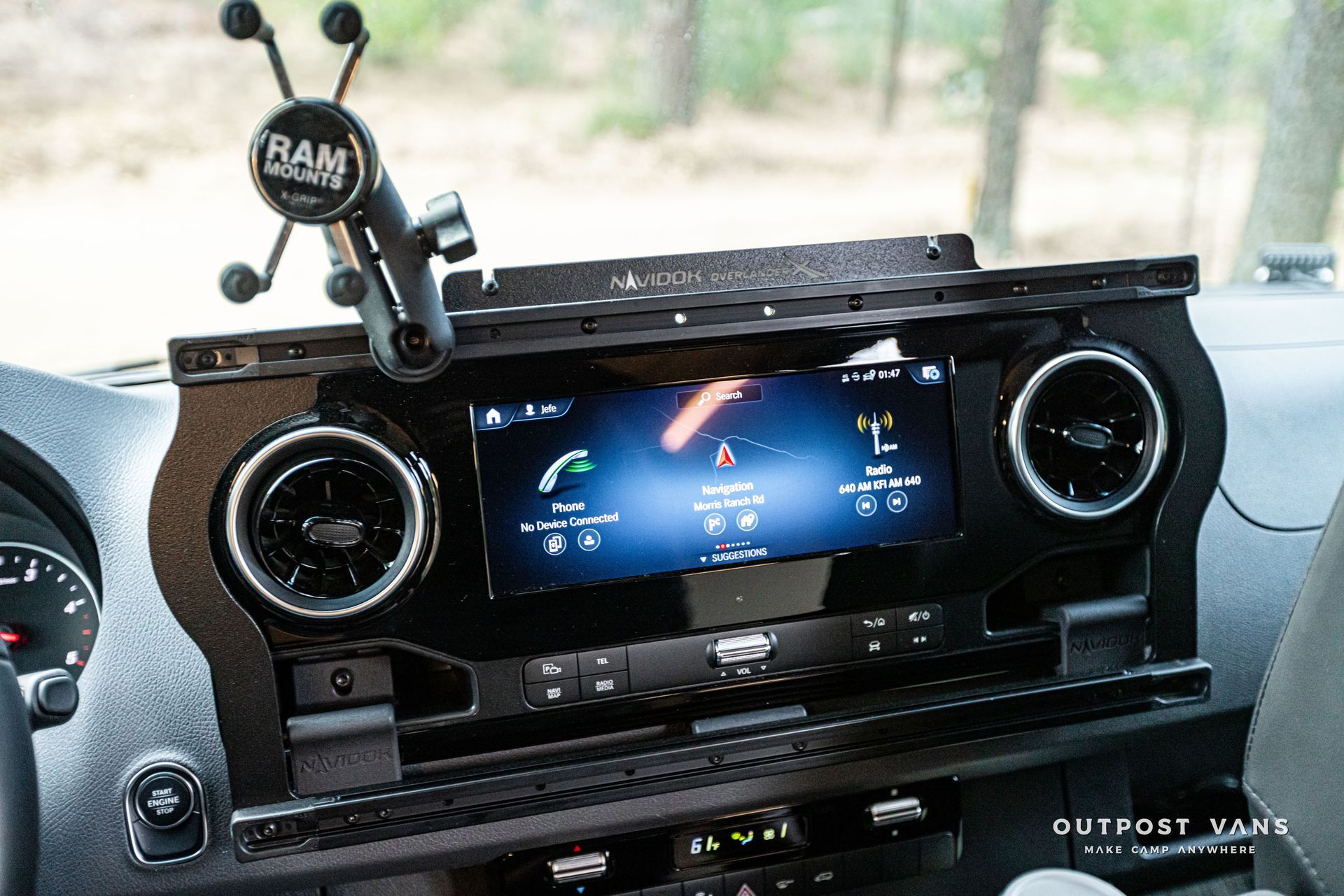 A car dashboard with a ram phone holder attached to it.
