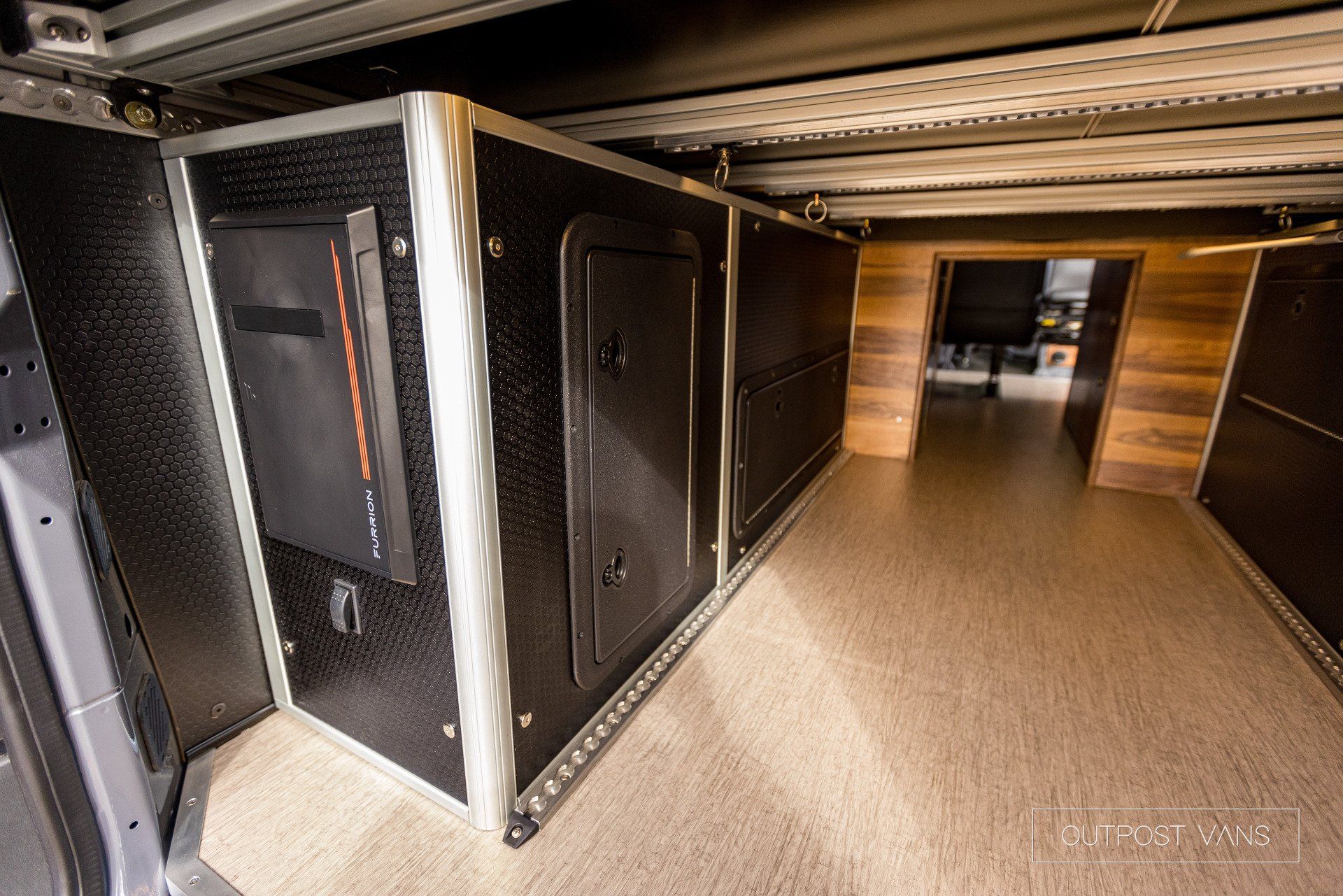 The inside of a van with a lot of cabinets and drawers.