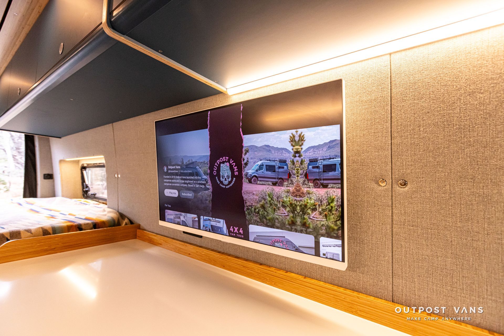 A bedroom with a large flat screen tv on the wall.