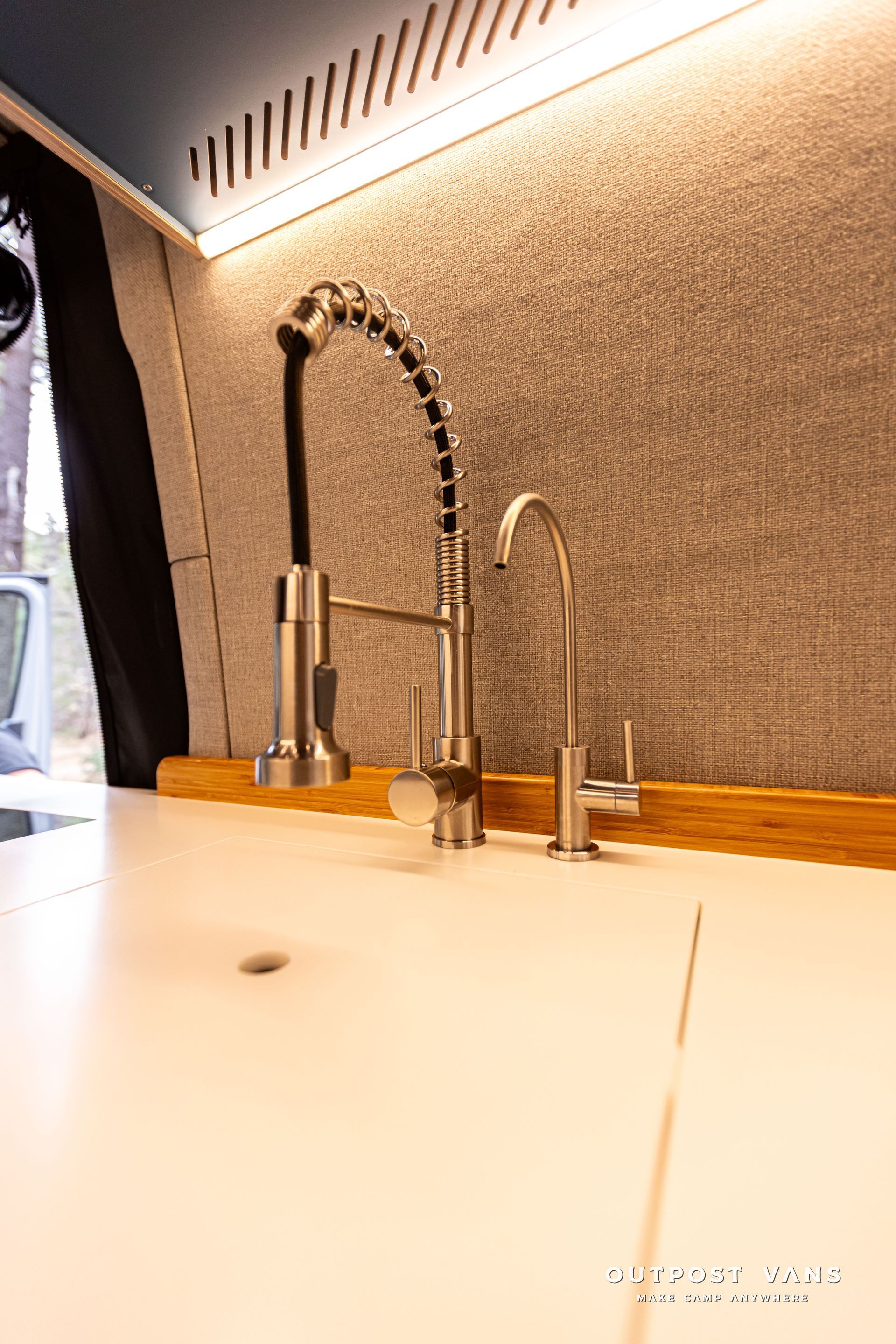 A close up of a kitchen sink in a van.