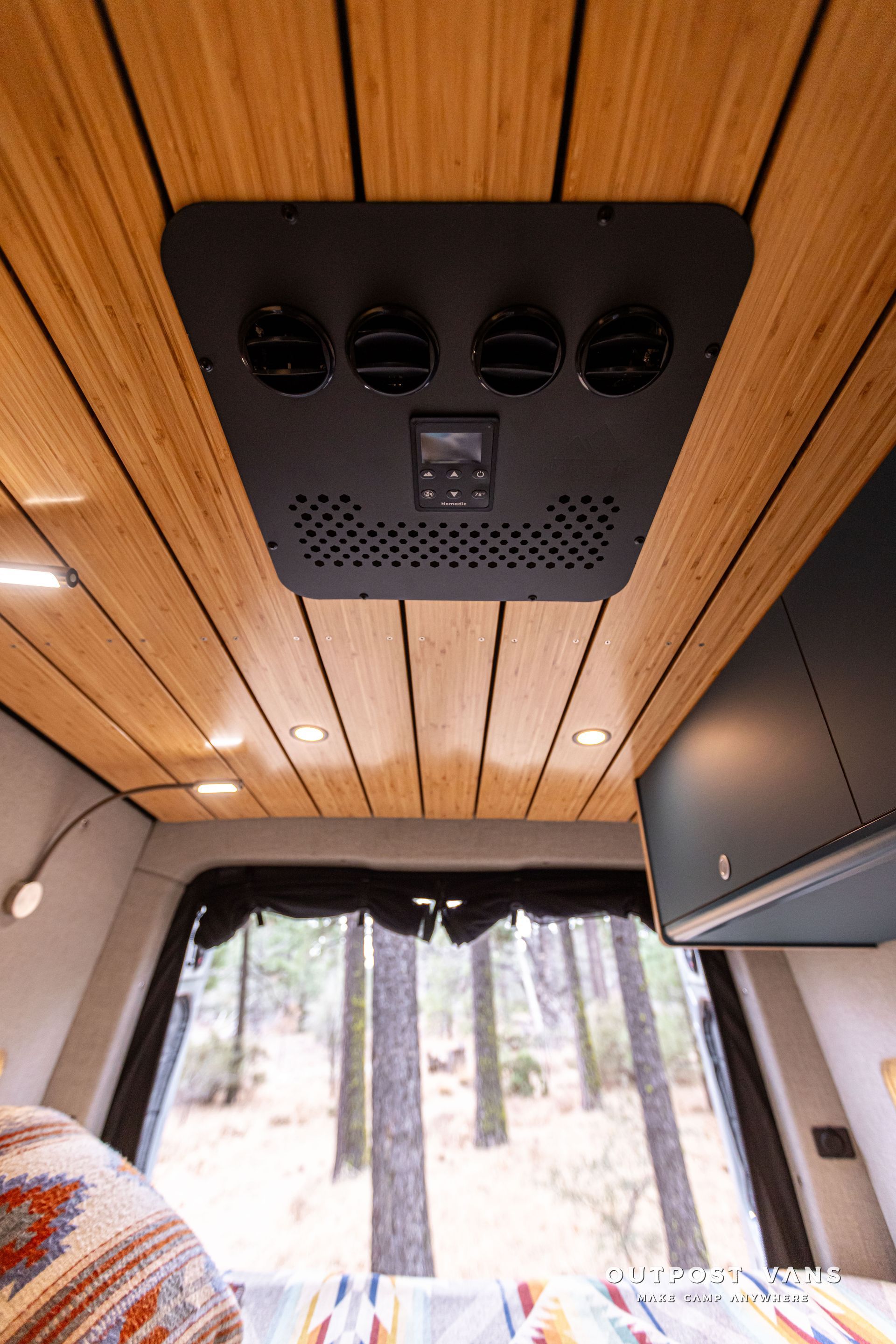 A van with a wooden ceiling and a ceiling fan.