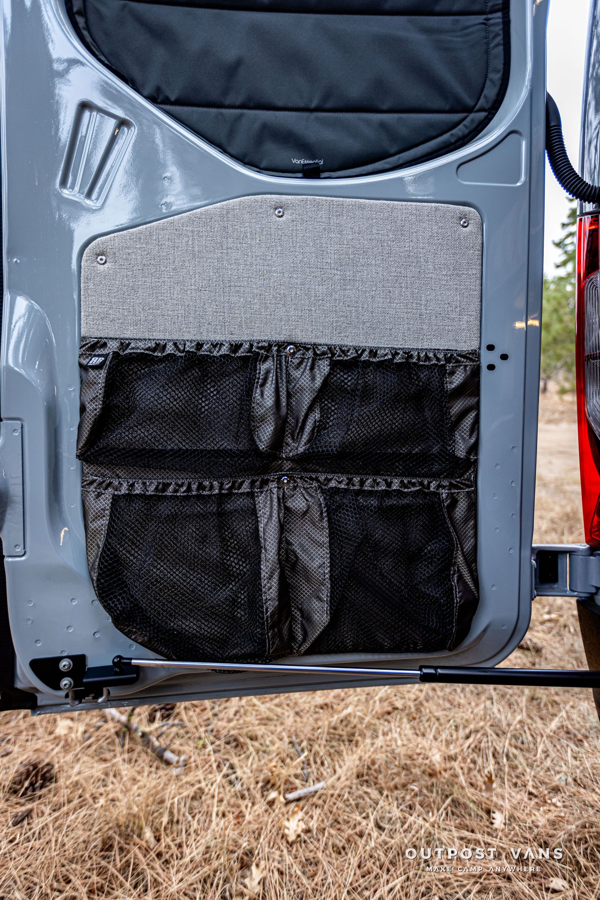 A close up of a door with pockets on it in a field.