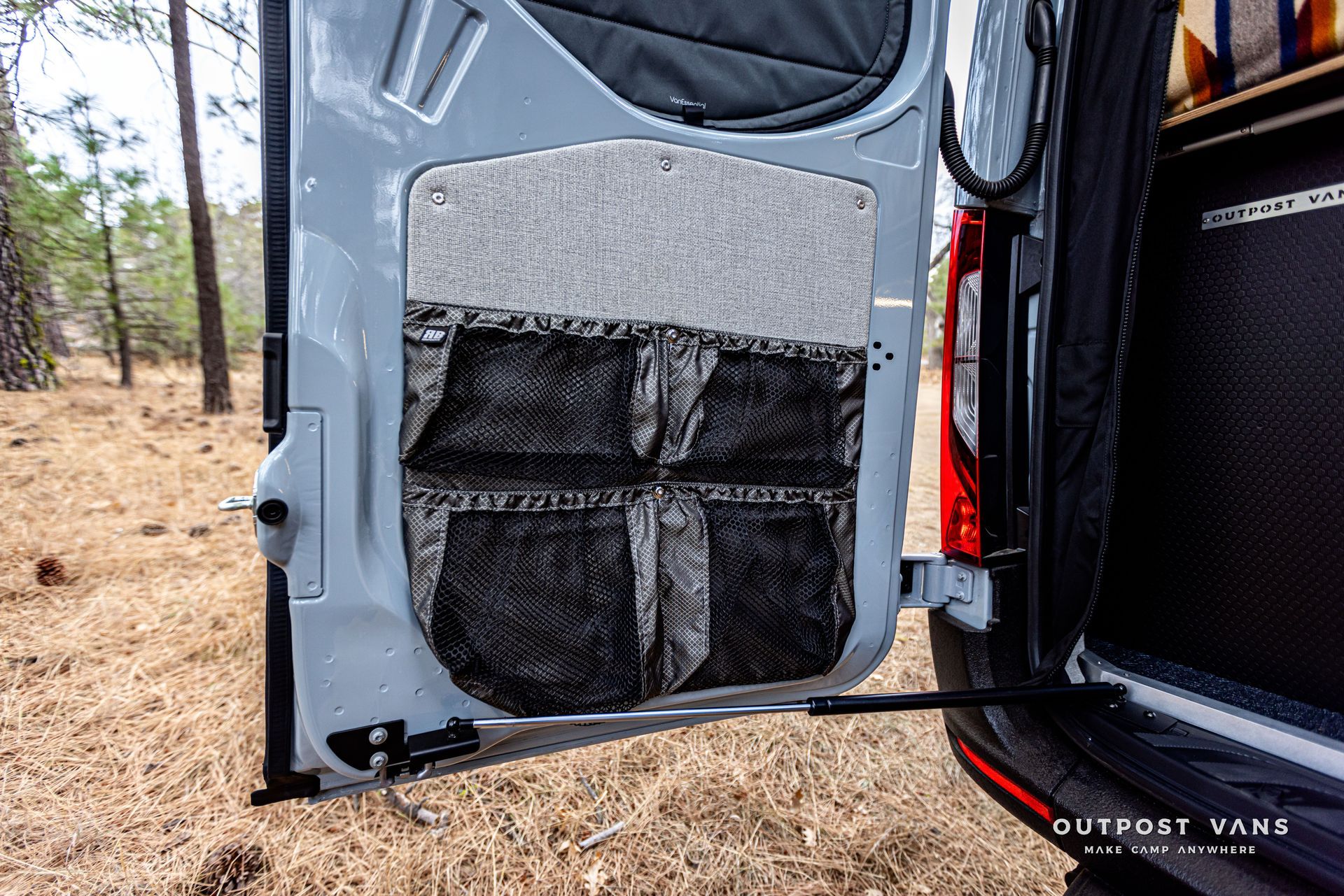 The door of a van is open and there are pockets in it.