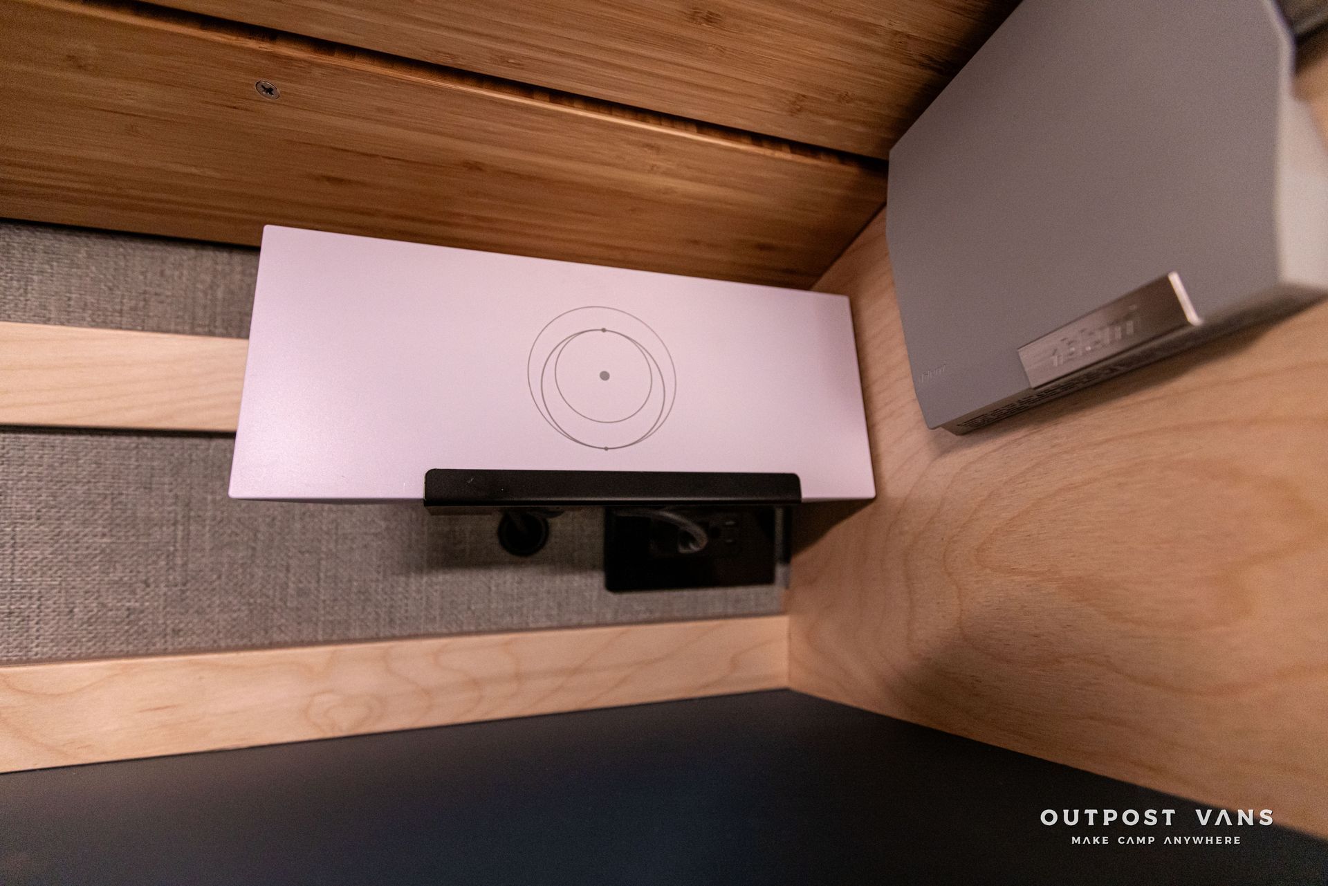 A white box is sitting on top of a wooden table in a room.