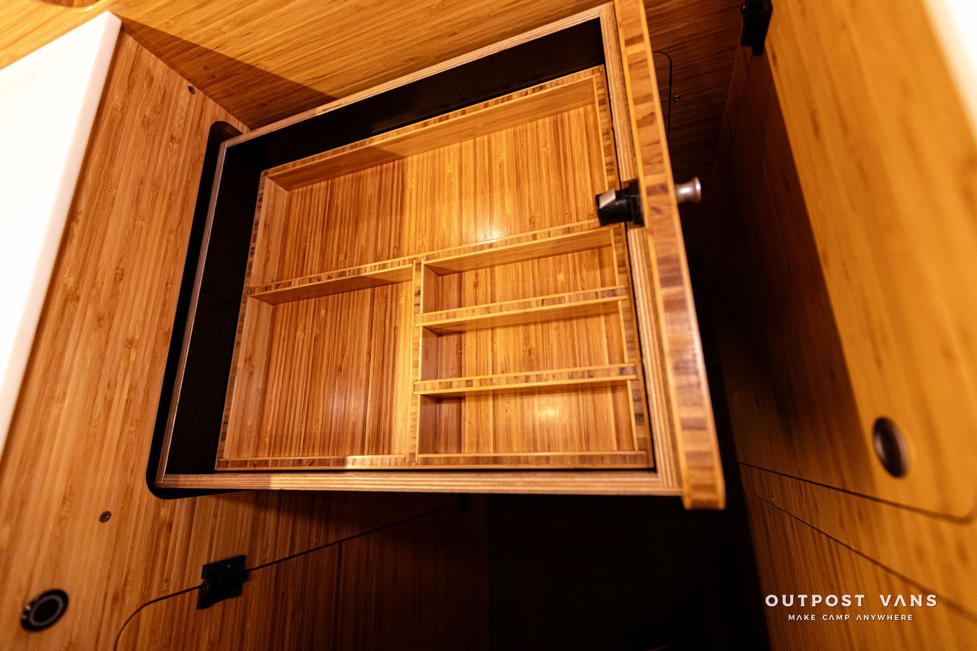 A wooden cabinet with a drawer and shelves inside of it.