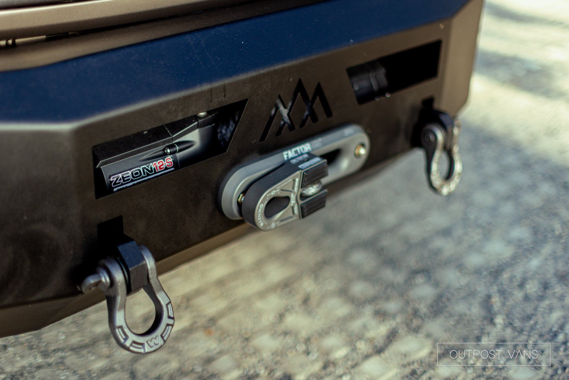 a close up of a truck 's bumper with a winch attached to it .