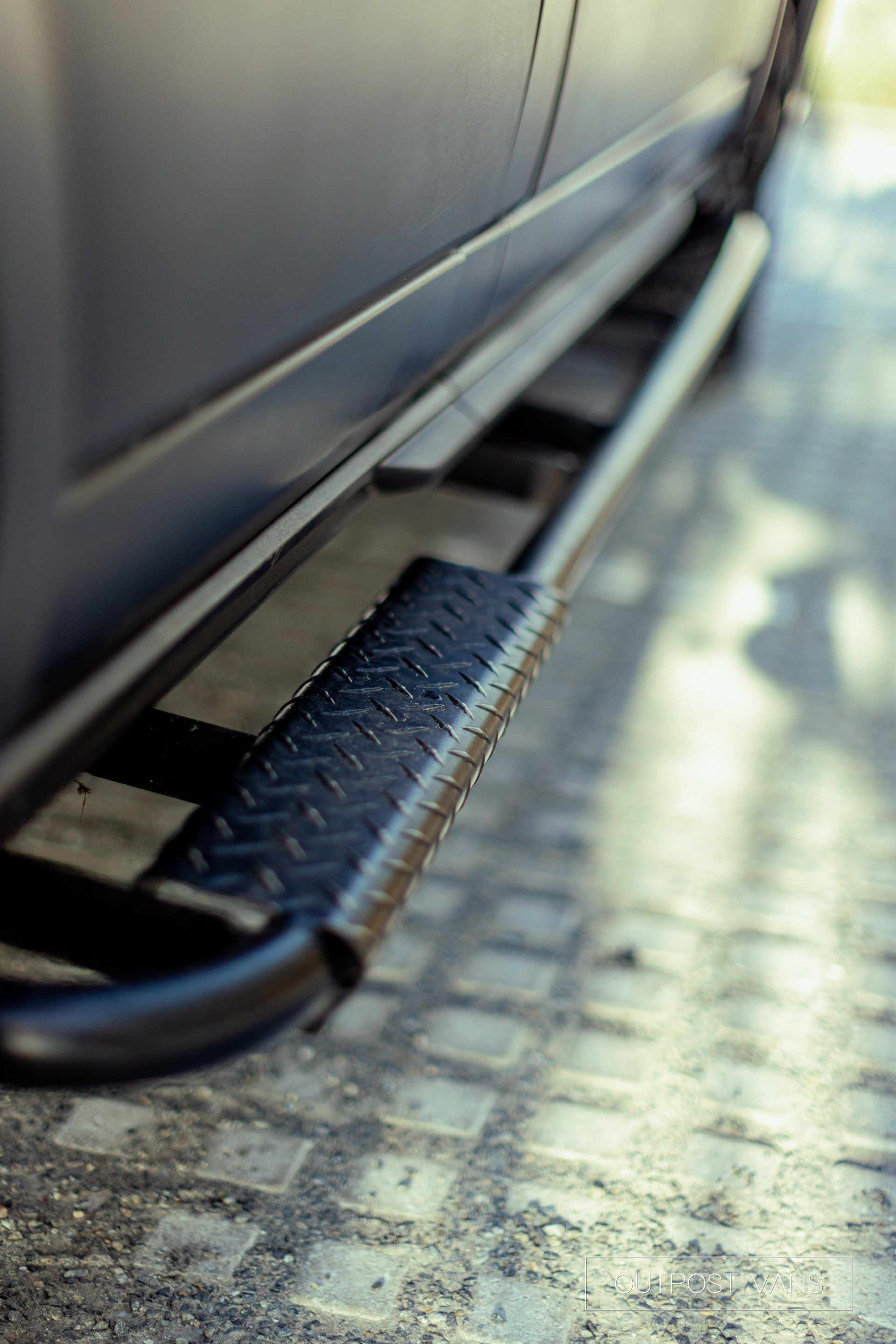 a close up of a side step on the side of a car .