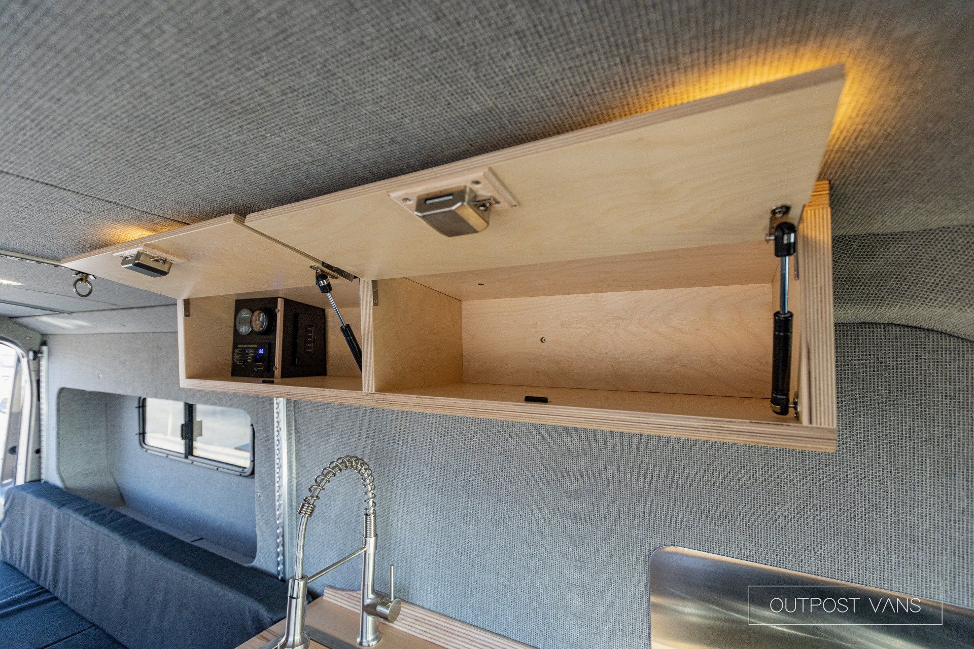a wooden shelf is hanging from the ceiling of a van .