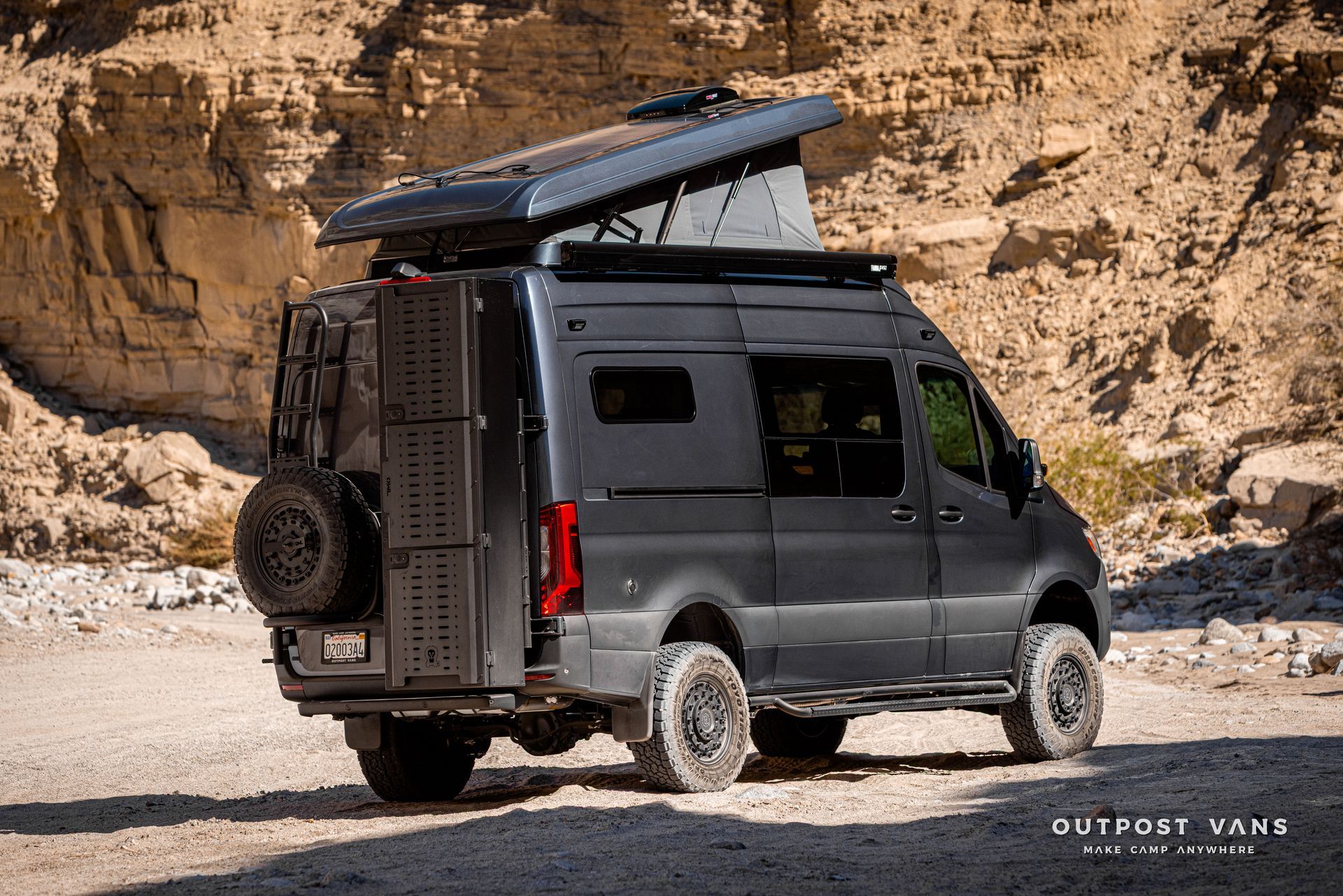 A sprinter van with a sca pop åtop at Fish Creek Anza Borrego. Owl vans tire carrier and ski box
