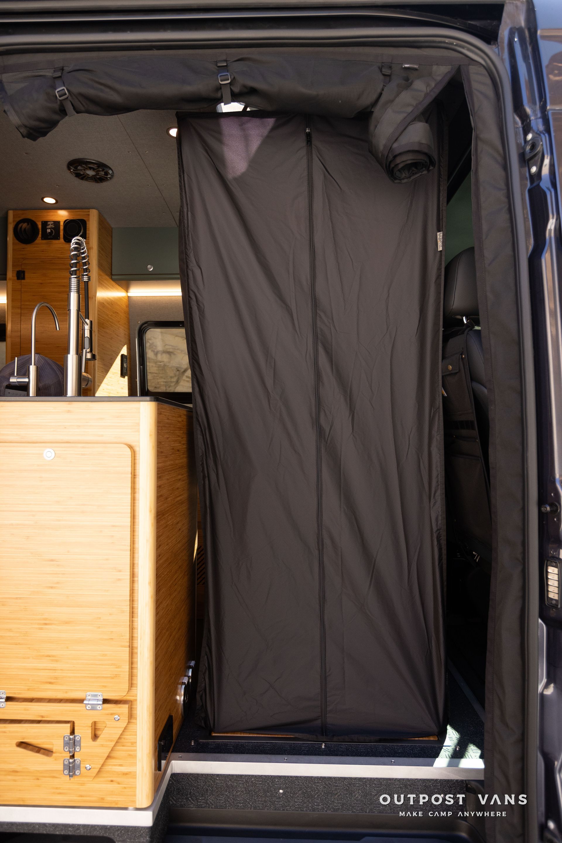 Outpost vans in the floor shower pan with bamboo insert shower hose and mixer. custom shower curtain