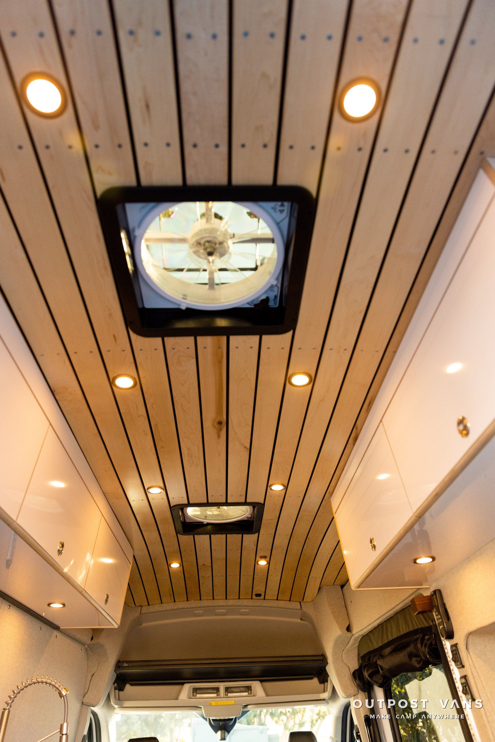 a van with a wooden ceiling and a fan