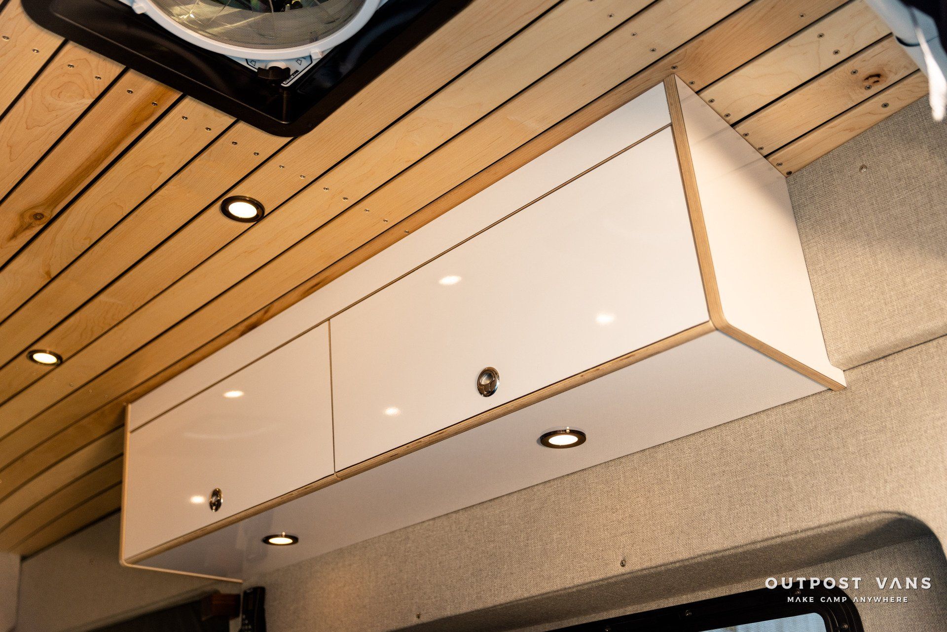 a white cabinet is hanging from the ceiling of a van