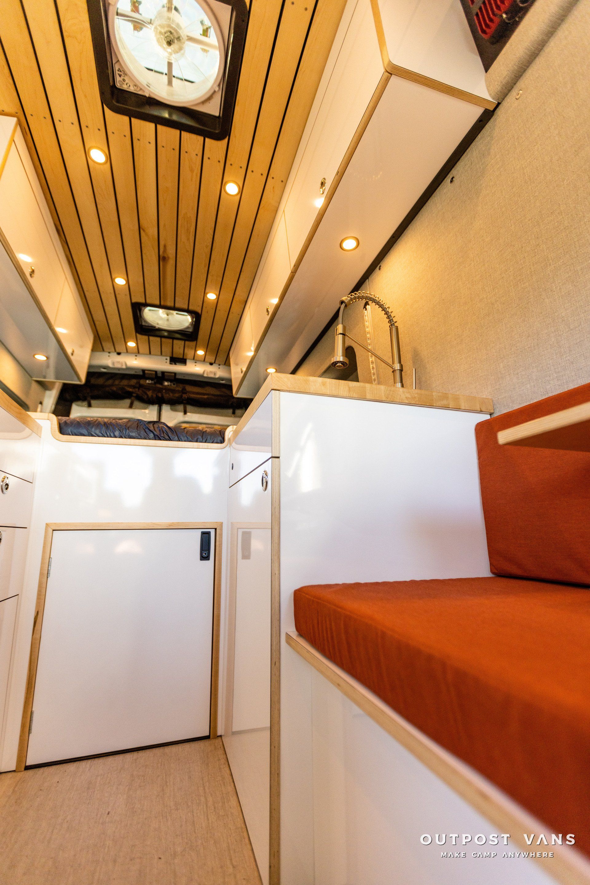 the inside of a camper van with a clock on the ceiling