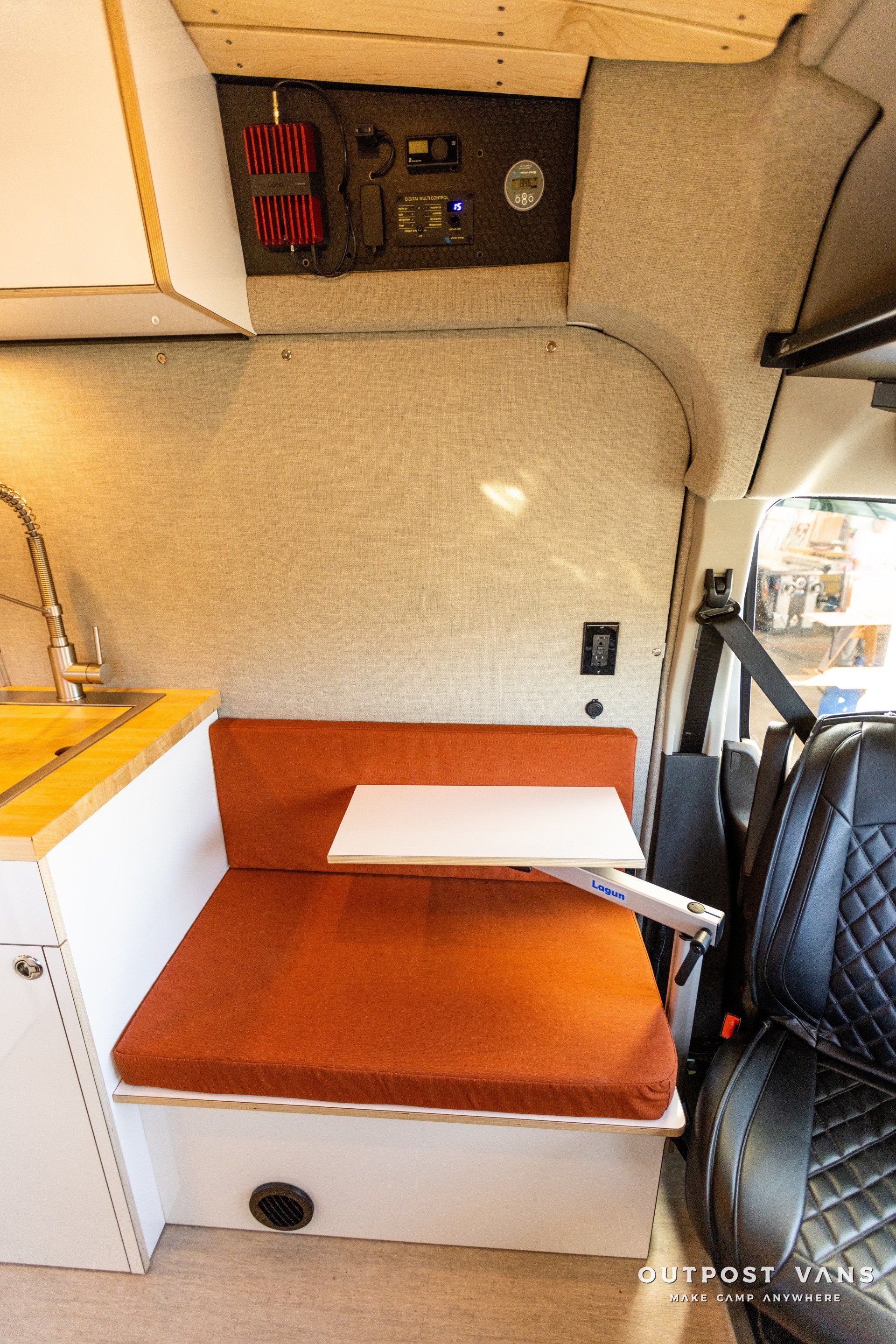 a camper van with a table in the back seat .