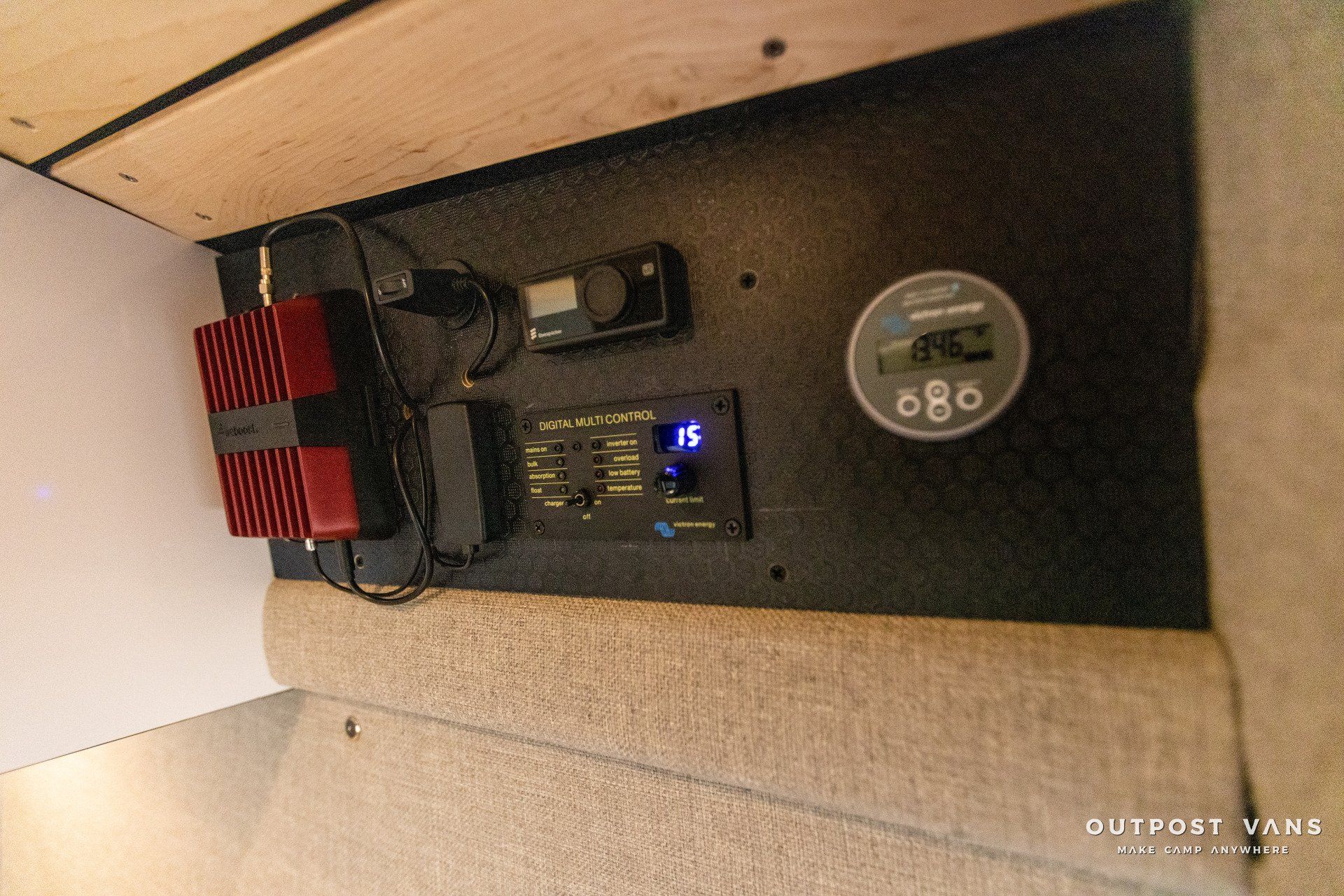 a wall with a bunch of electrical equipment on it .