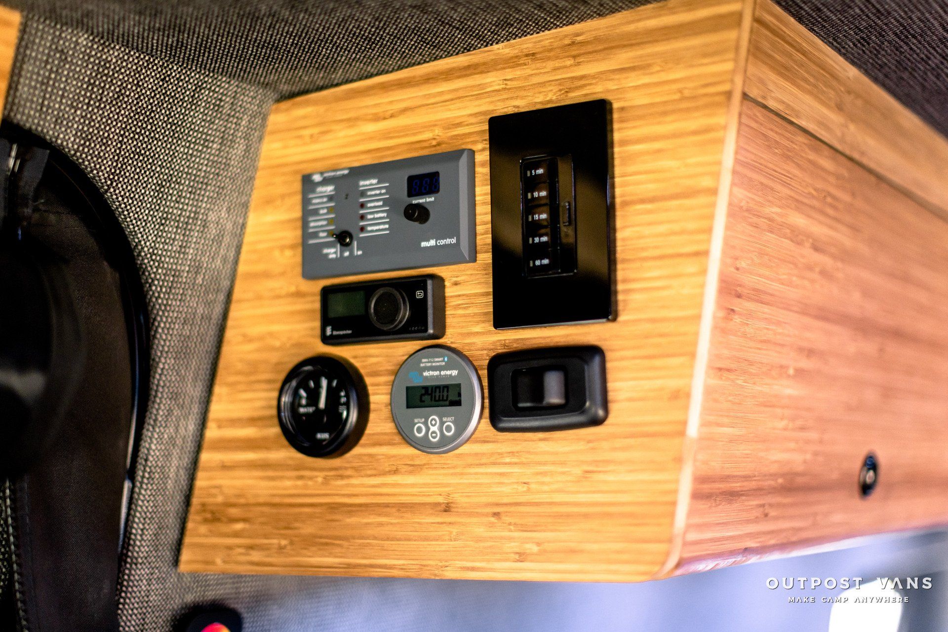 A wooden shelf with a bunch of electronics on it.