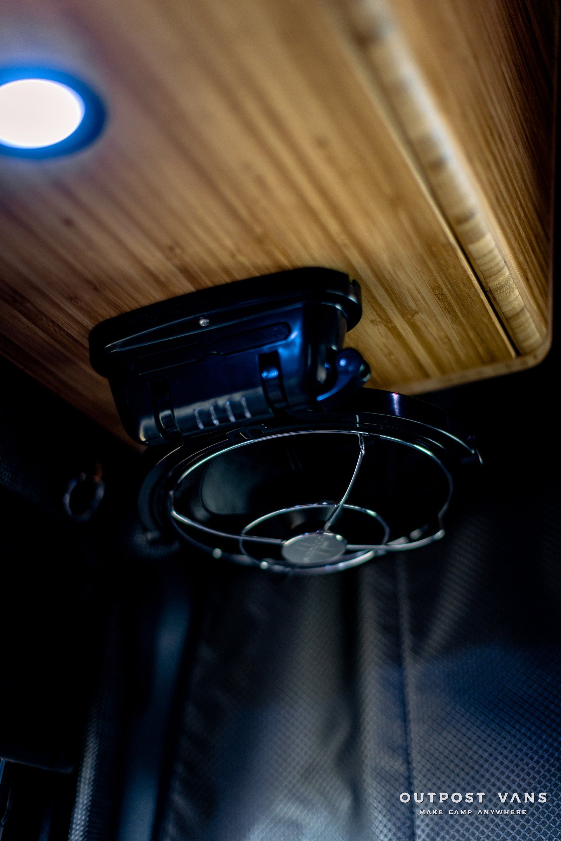 A fan is hanging from the ceiling of a van.