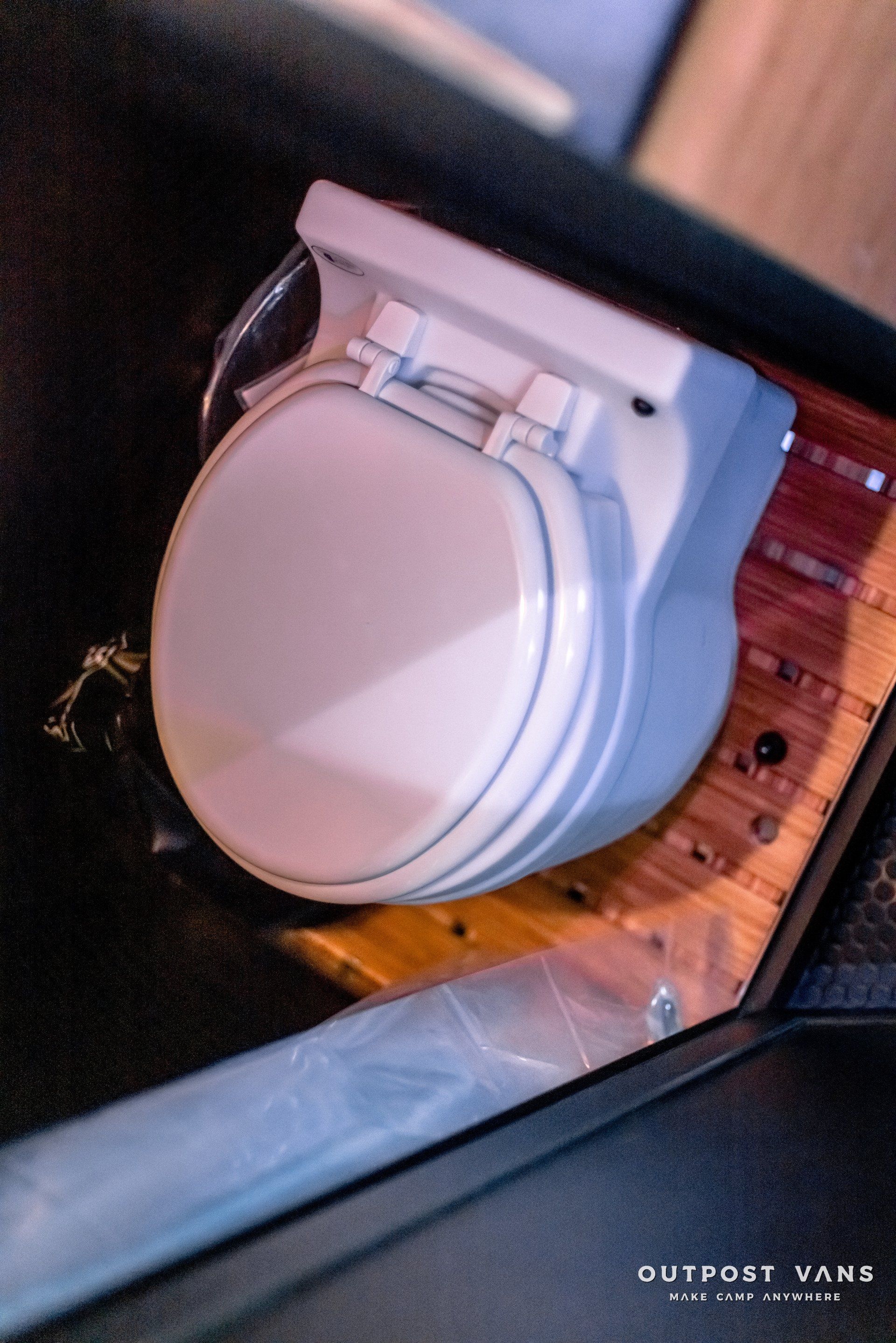 A close up of a toilet with the word outport vans on the bottom