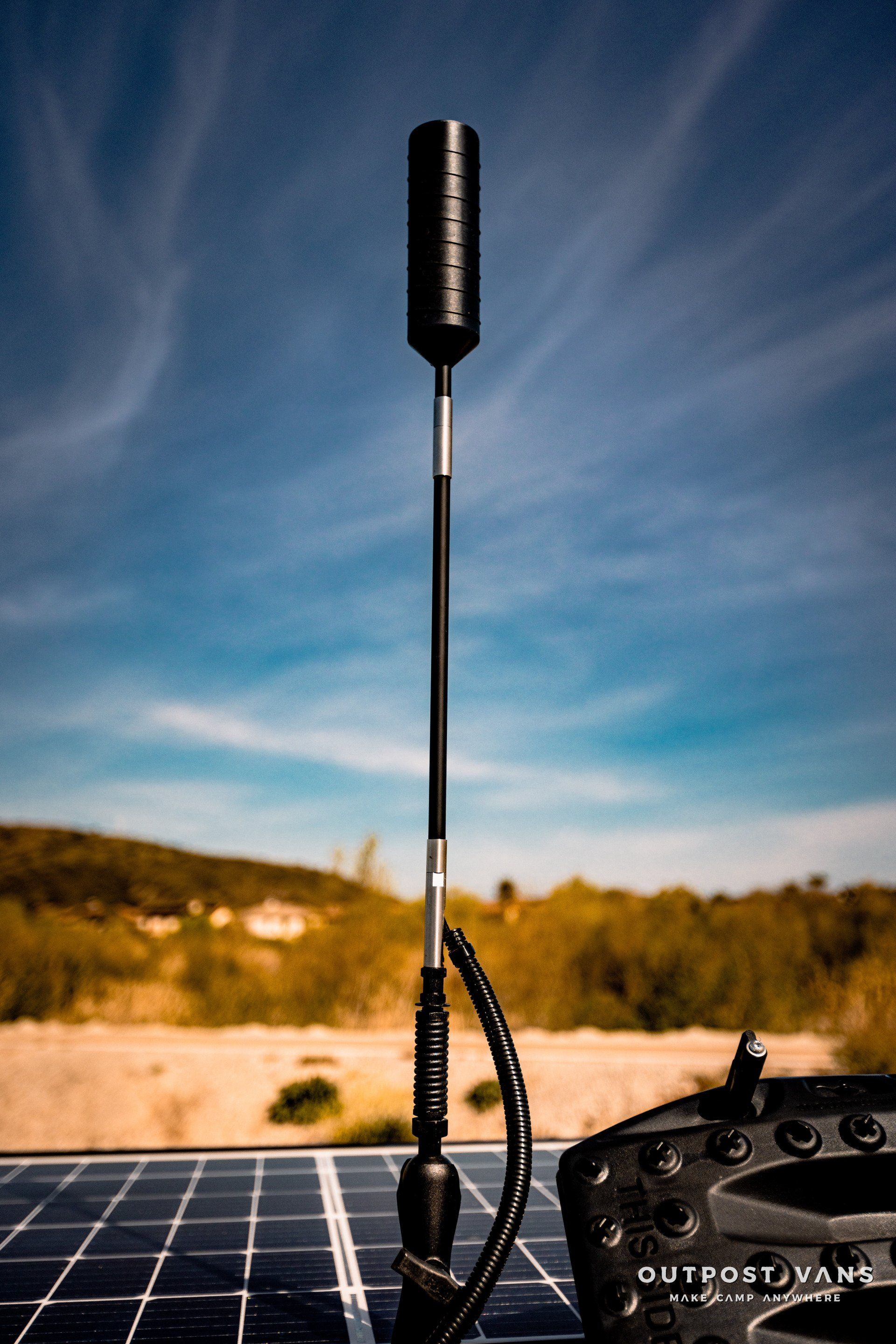 A remote control is sitting on top of a solar panel.