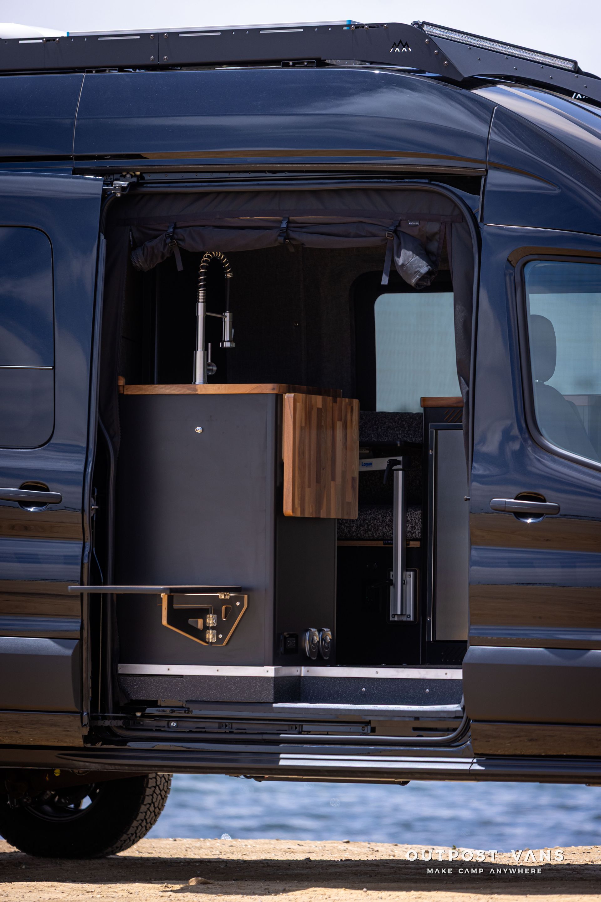 Outpost Vans custom built camper van Ford Transit 148 AWD. flip down table