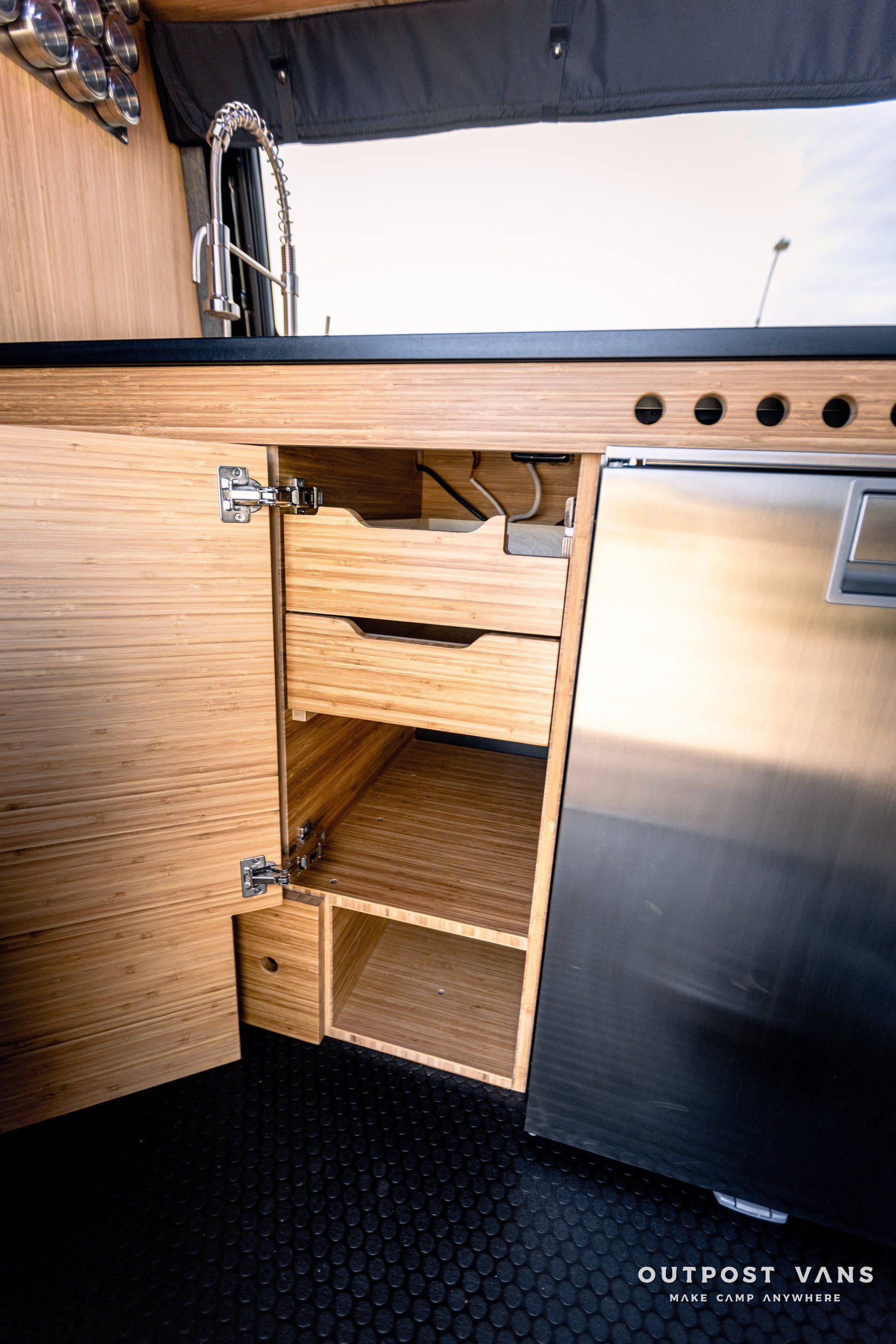 A kitchen with stainless steel appliances and wooden cabinets.