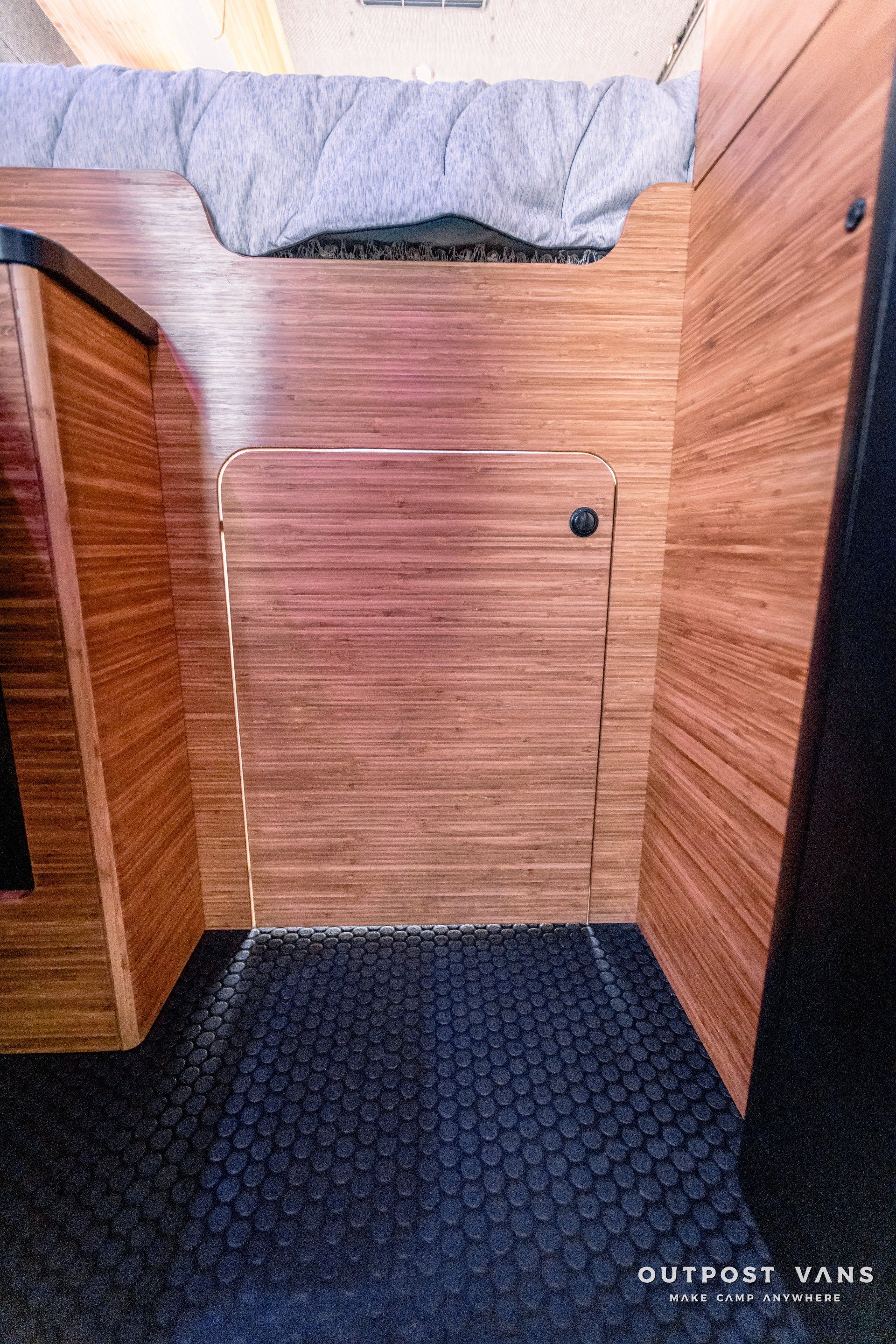 A room with a wooden wall and a door.