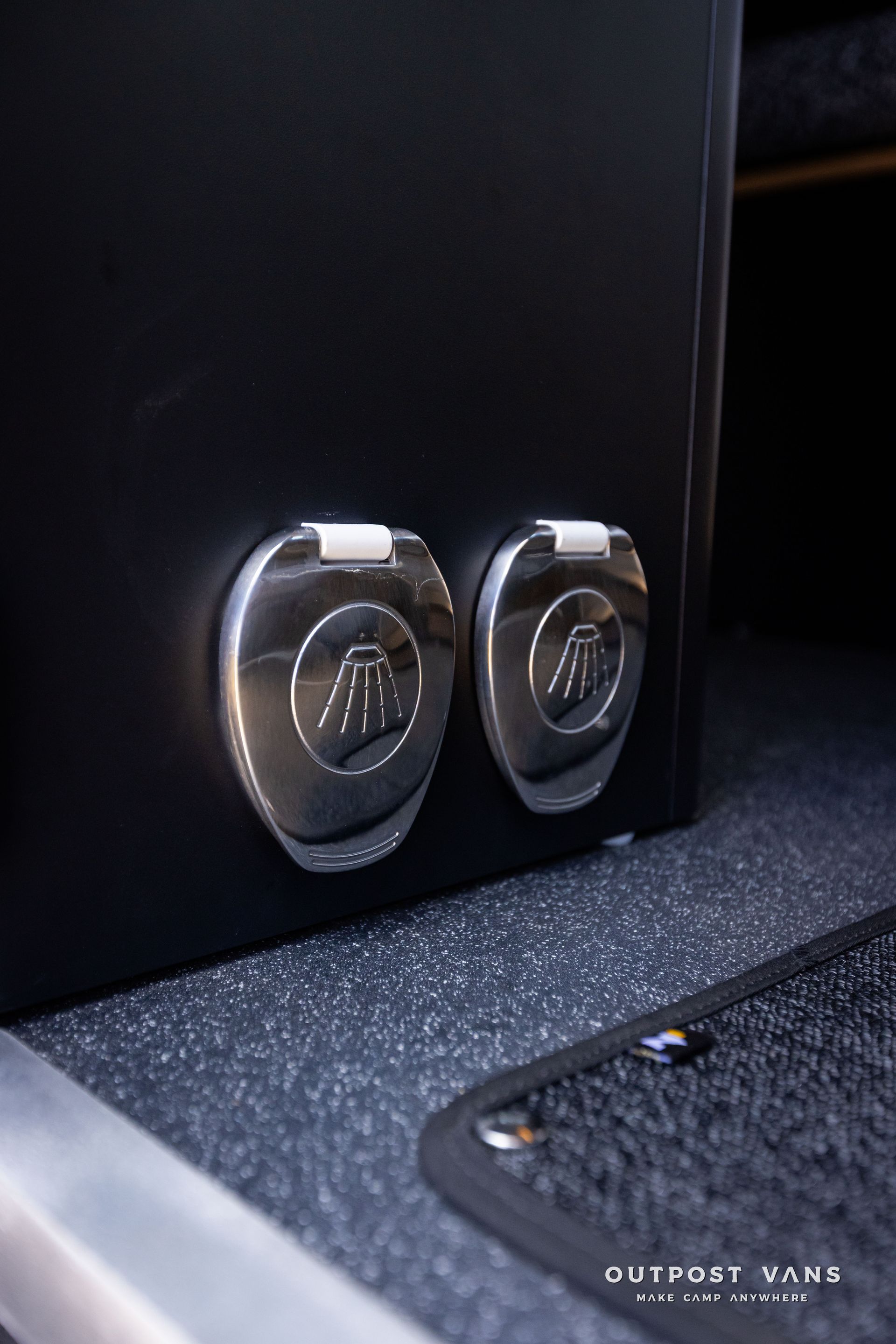 Outpost Vans custom built camper van Ford Transit 148 AWD. In floor shower pan fixture and mixer