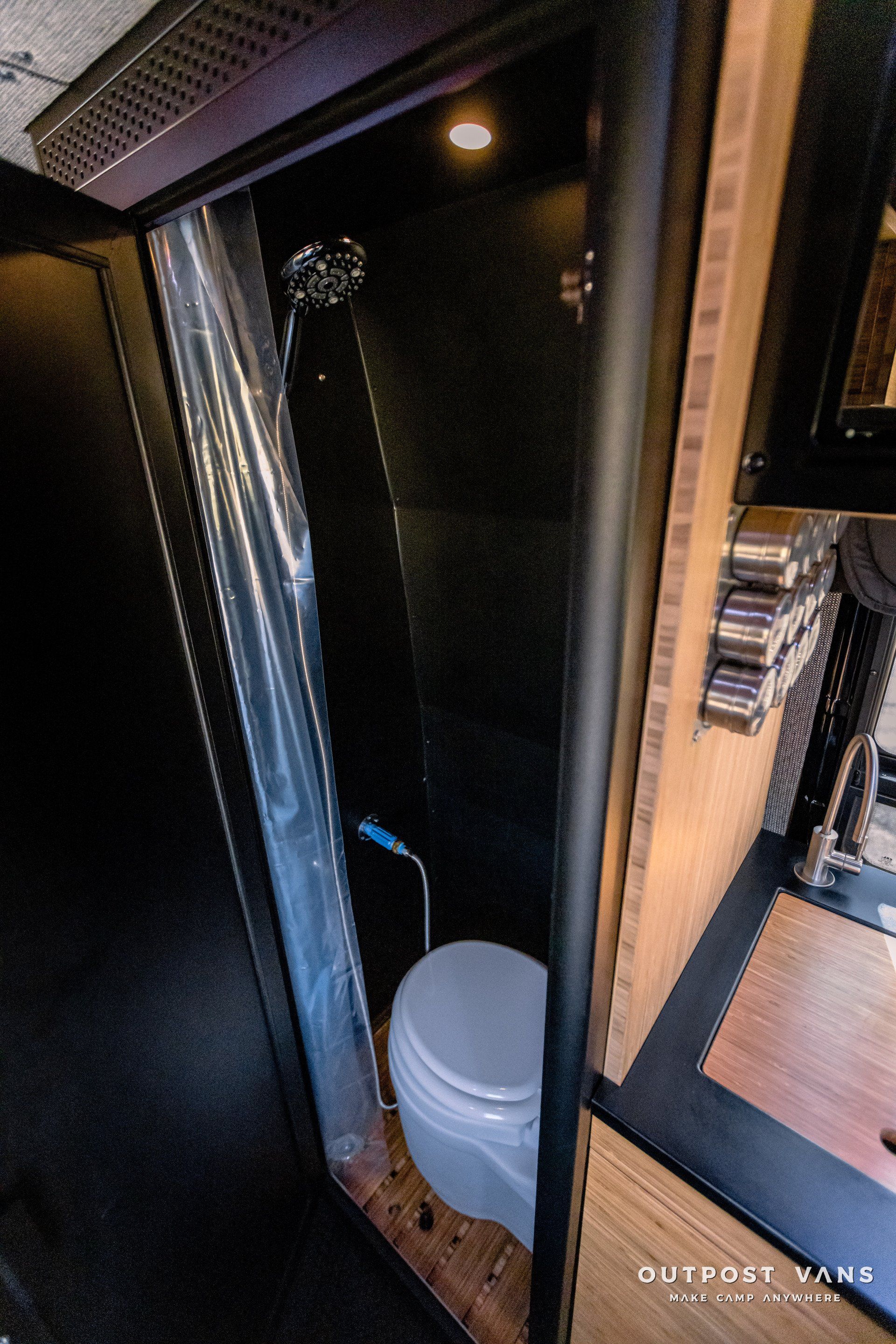 A bathroom with a toilet and a shower curtain.