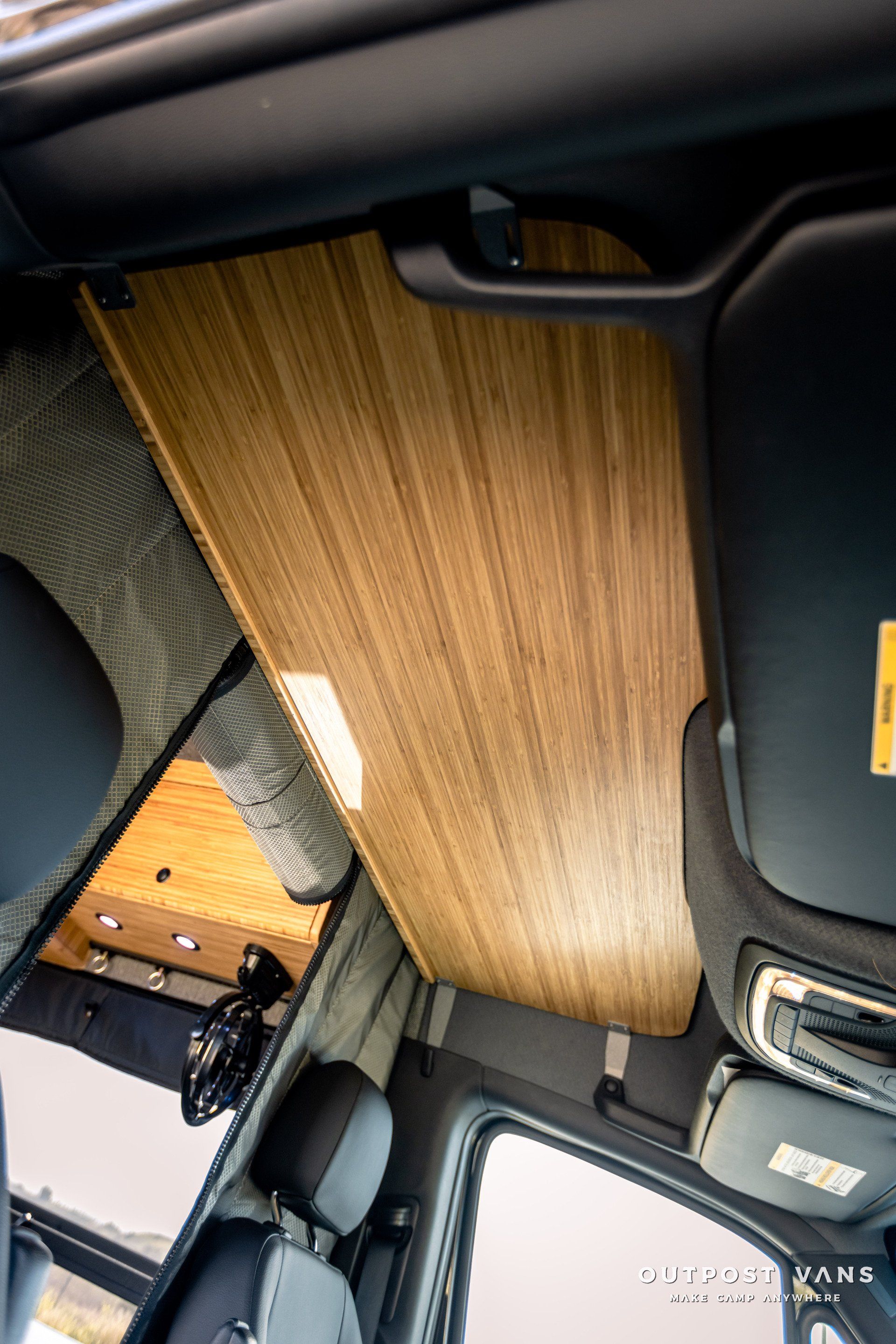 Looking up at the ceiling of a car with a wooden ceiling.