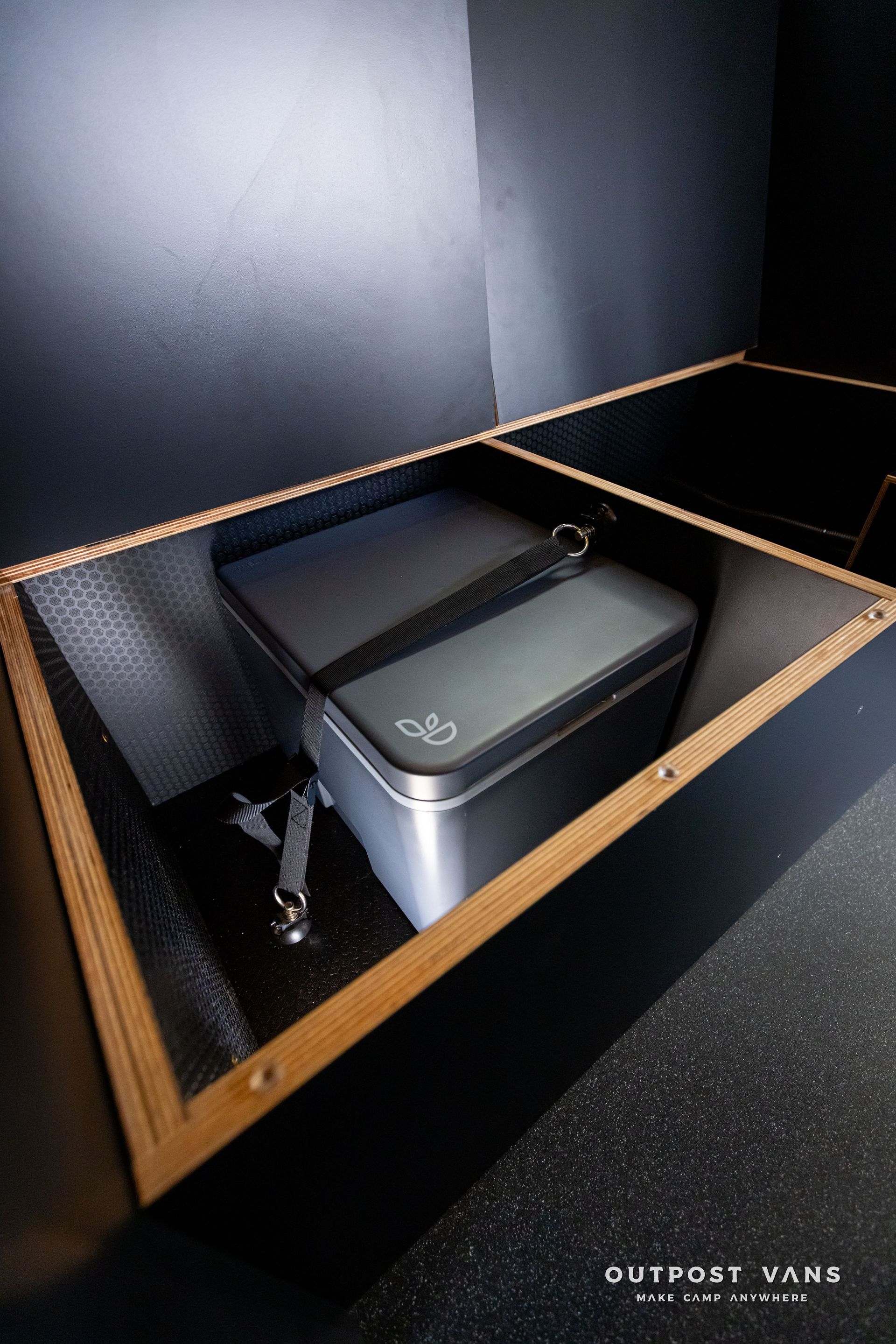 Outpost Vans custom built camper van Ford Transit 148 AWD. cassette toilet storage in bench seat