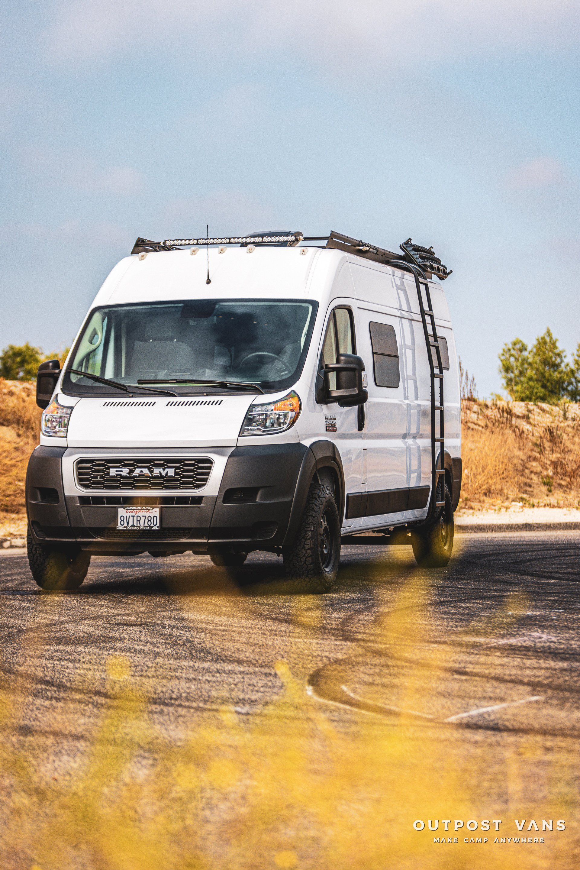 a white van is parked on the side of the road .