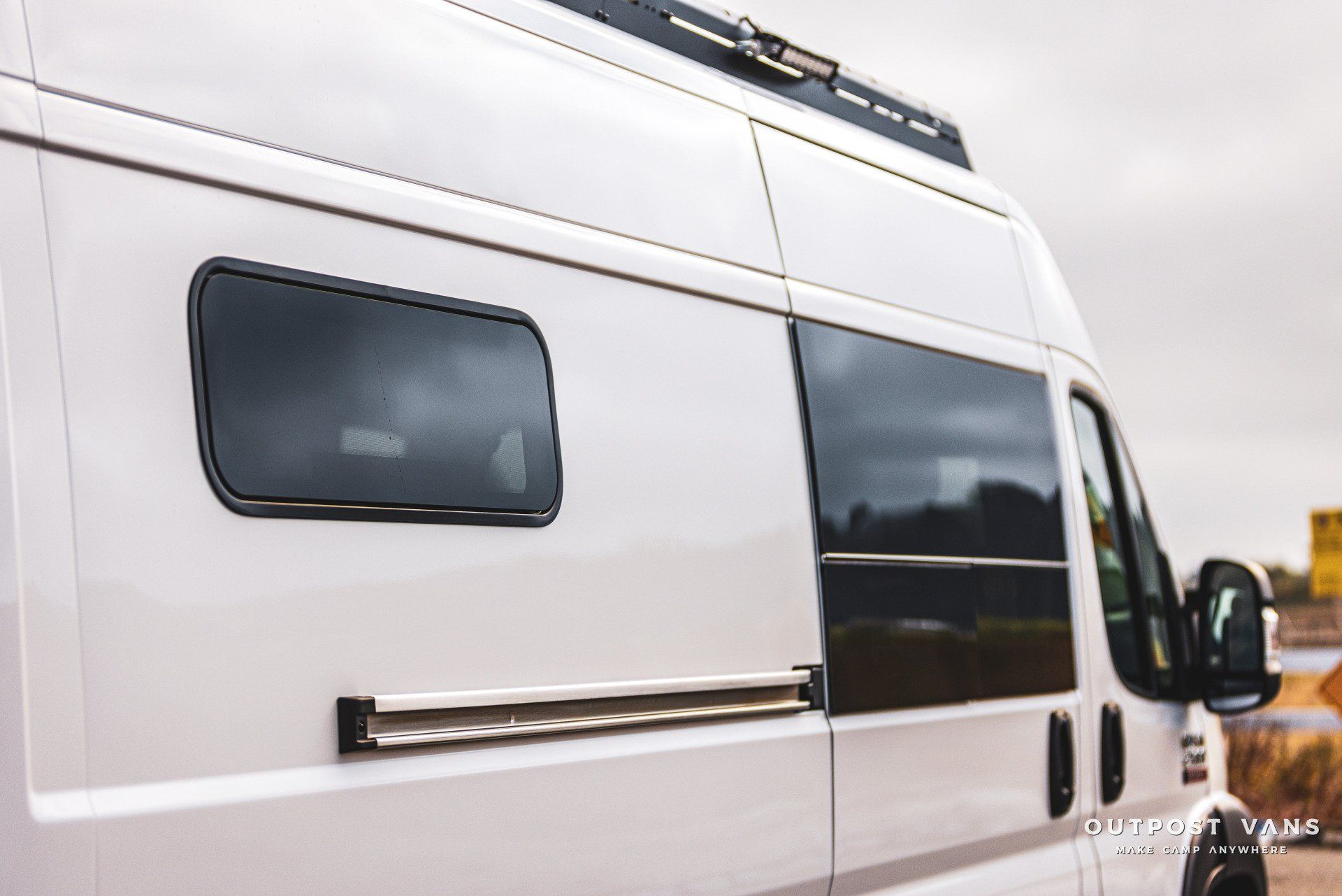 a white van with a roof rack on top of it