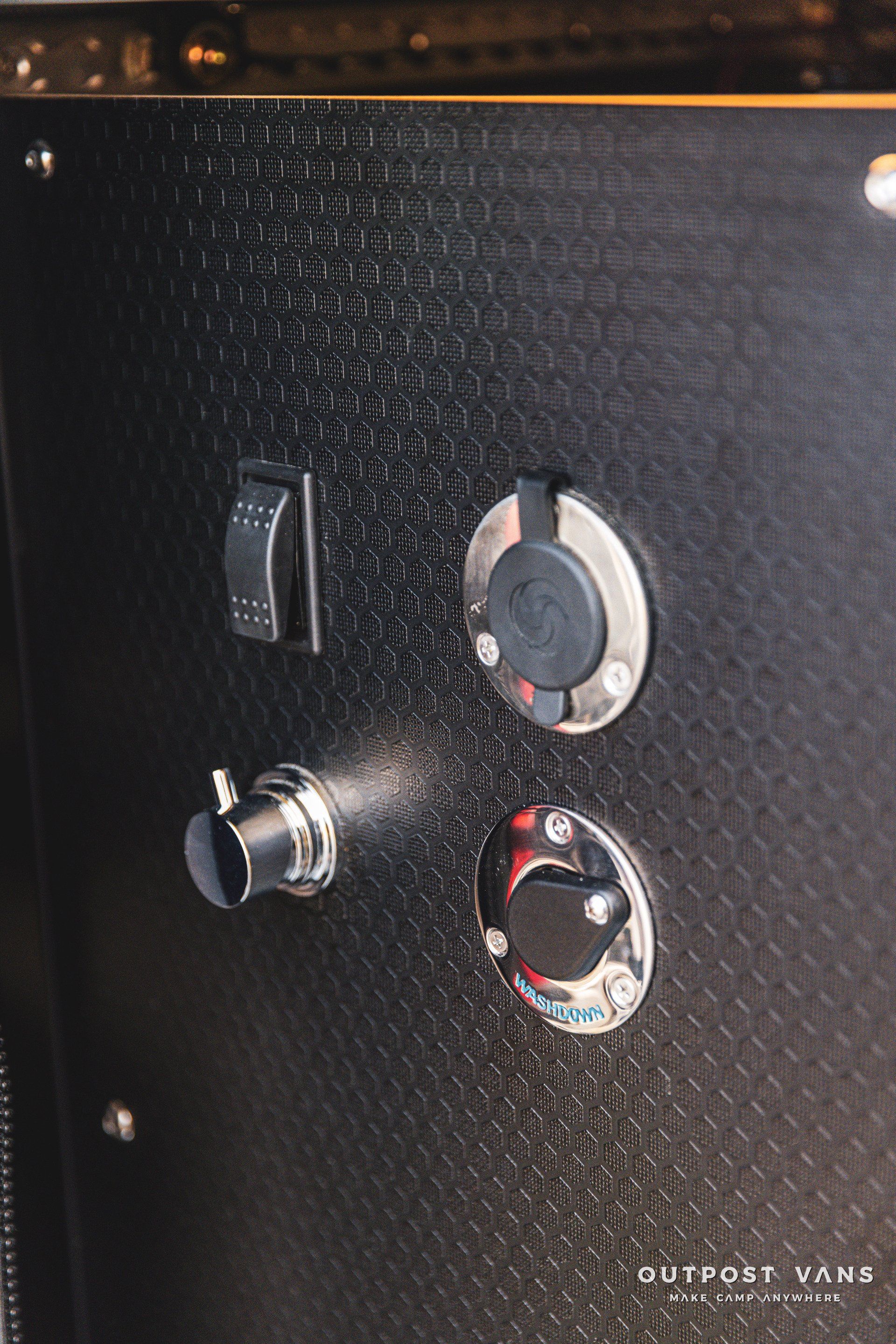 A close up of a shower head on a wall.