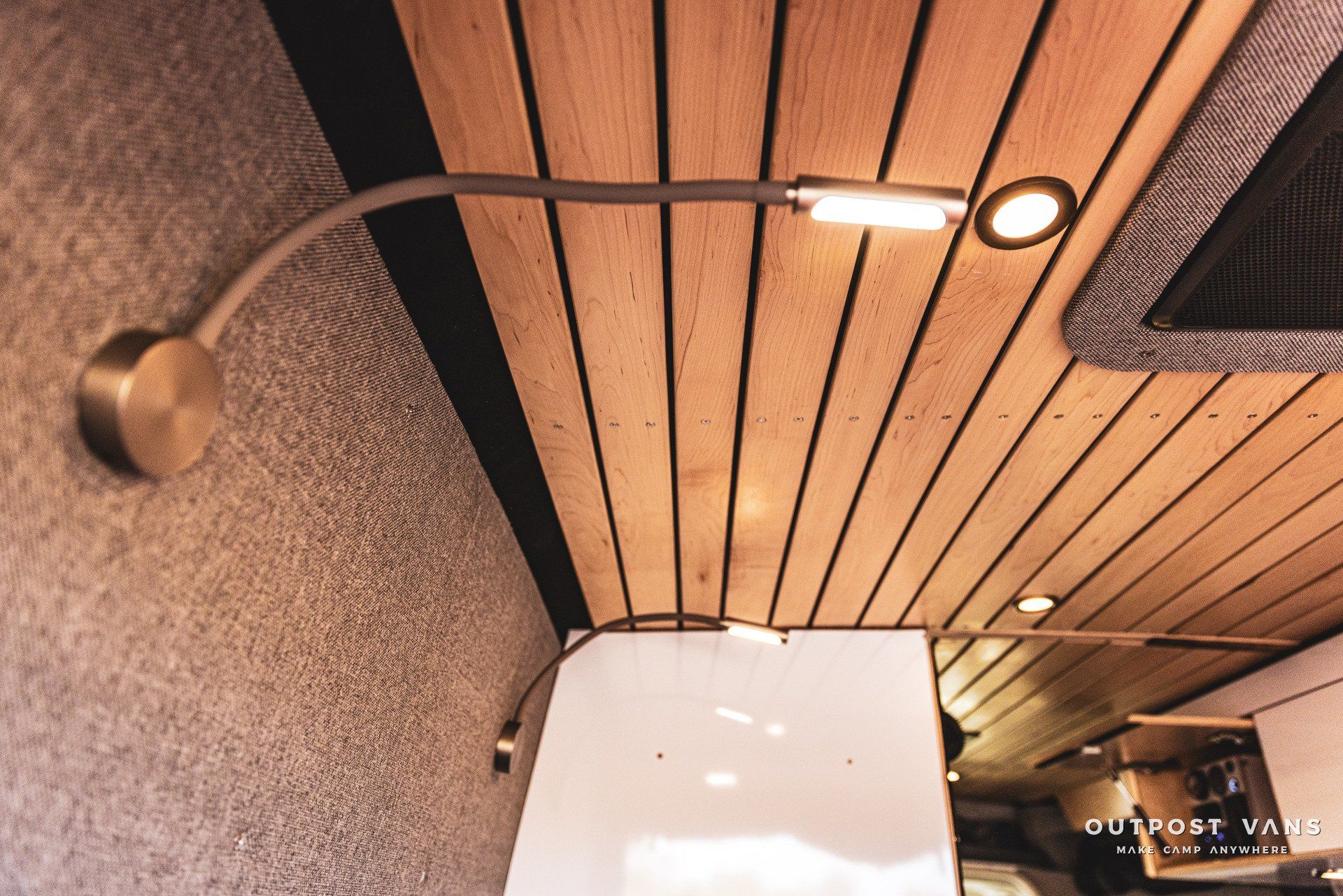 A wooden ceiling with a light hanging from it
