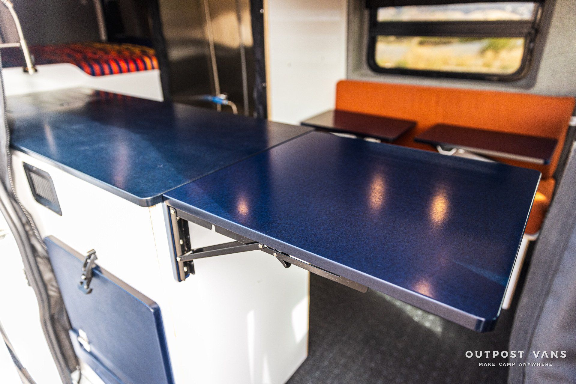 a van with a blue table that can be pulled out