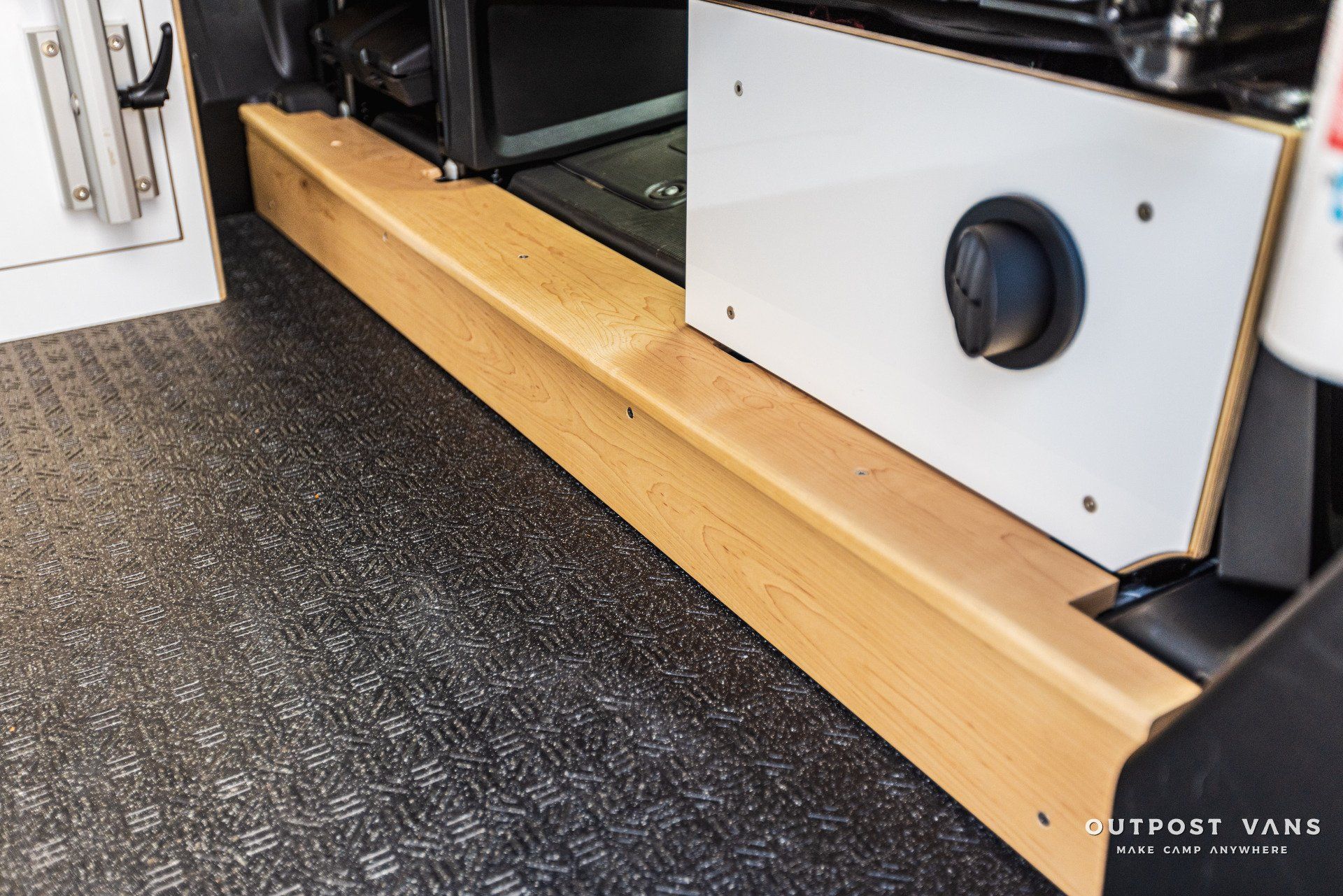 a wooden staircase leading to a stove in a camper van