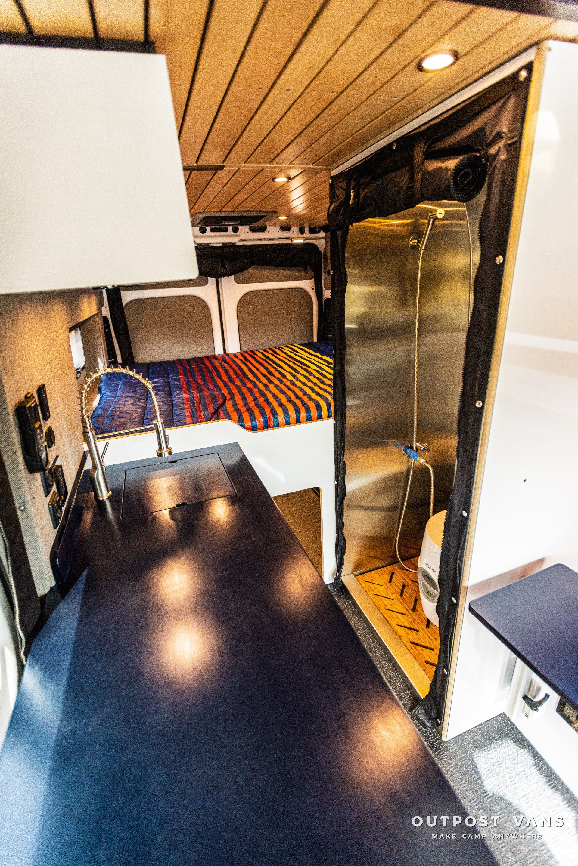 a kitchen with a sink and a bed in it